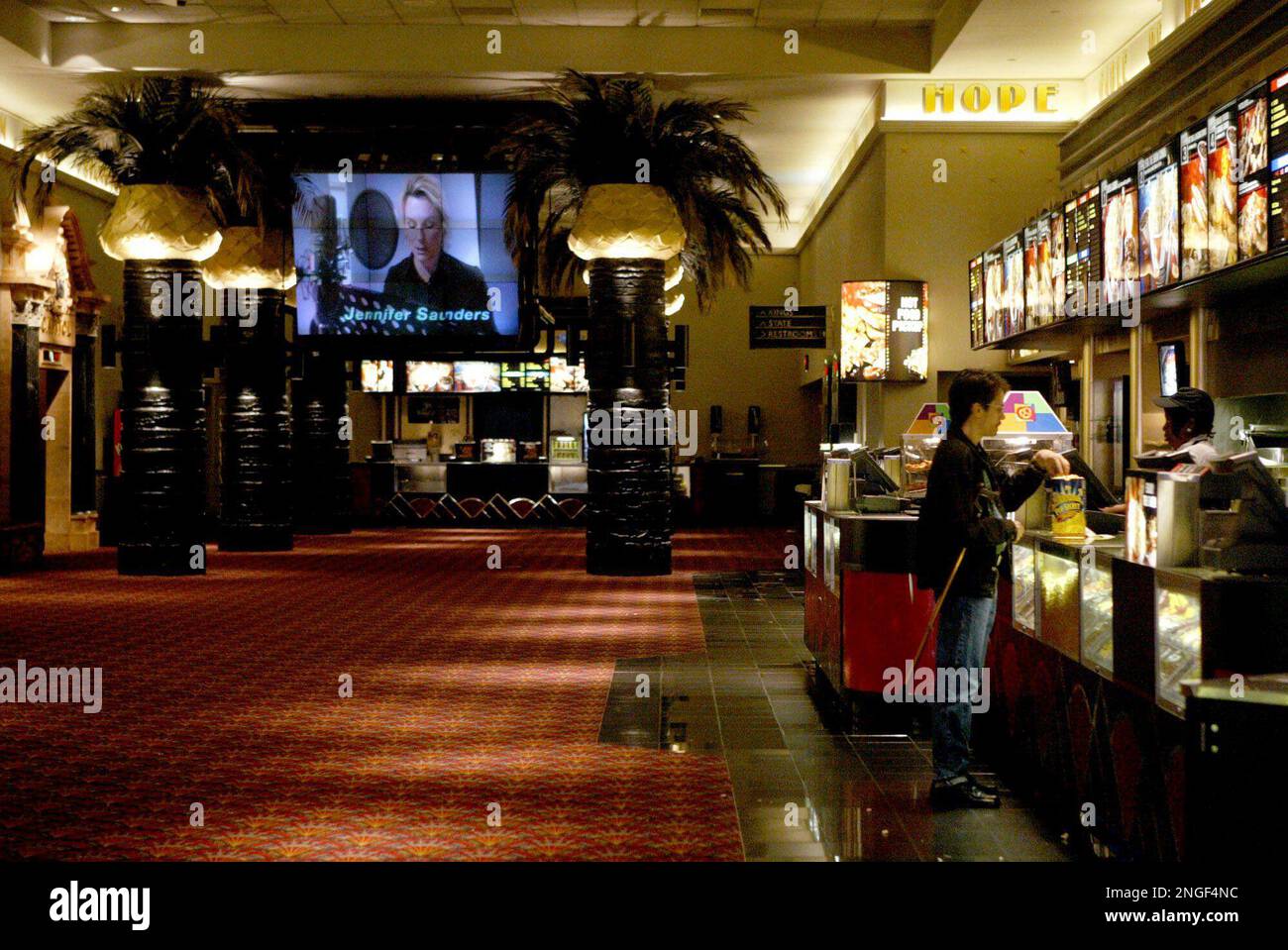 A customer buys popcorn at the main concession stand at the Loews