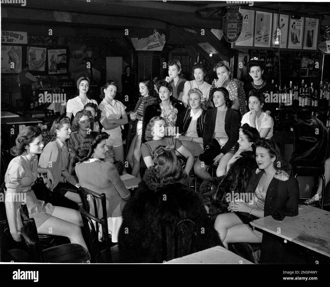 A group of chorus dancers, some wearing their costumes under their
