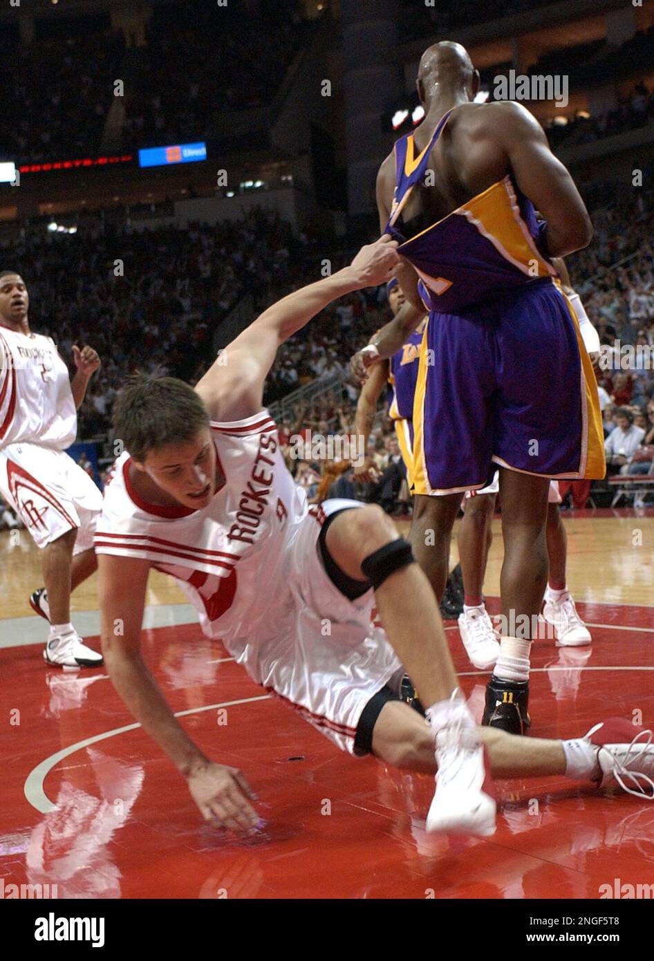 Houston Rockets' Bostjan Nachbar (9), of Slovenia, rips the jersey of Los  Angeles Lakers' Karl Malone after being fouled while going up for a shot  during the second quarter in Game 4