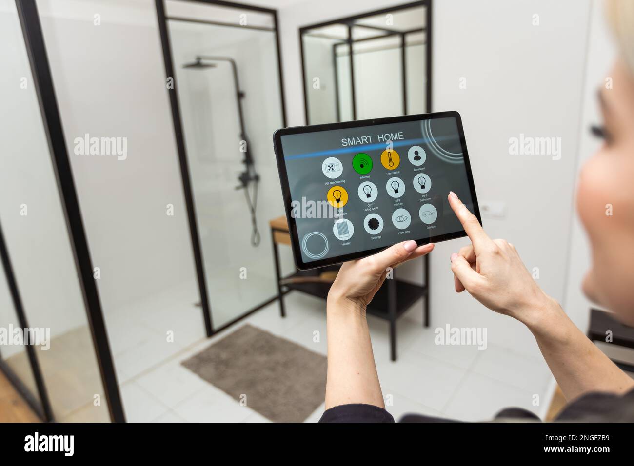 Digital composite of Hands using smart home application on tablet PC Stock Photo
