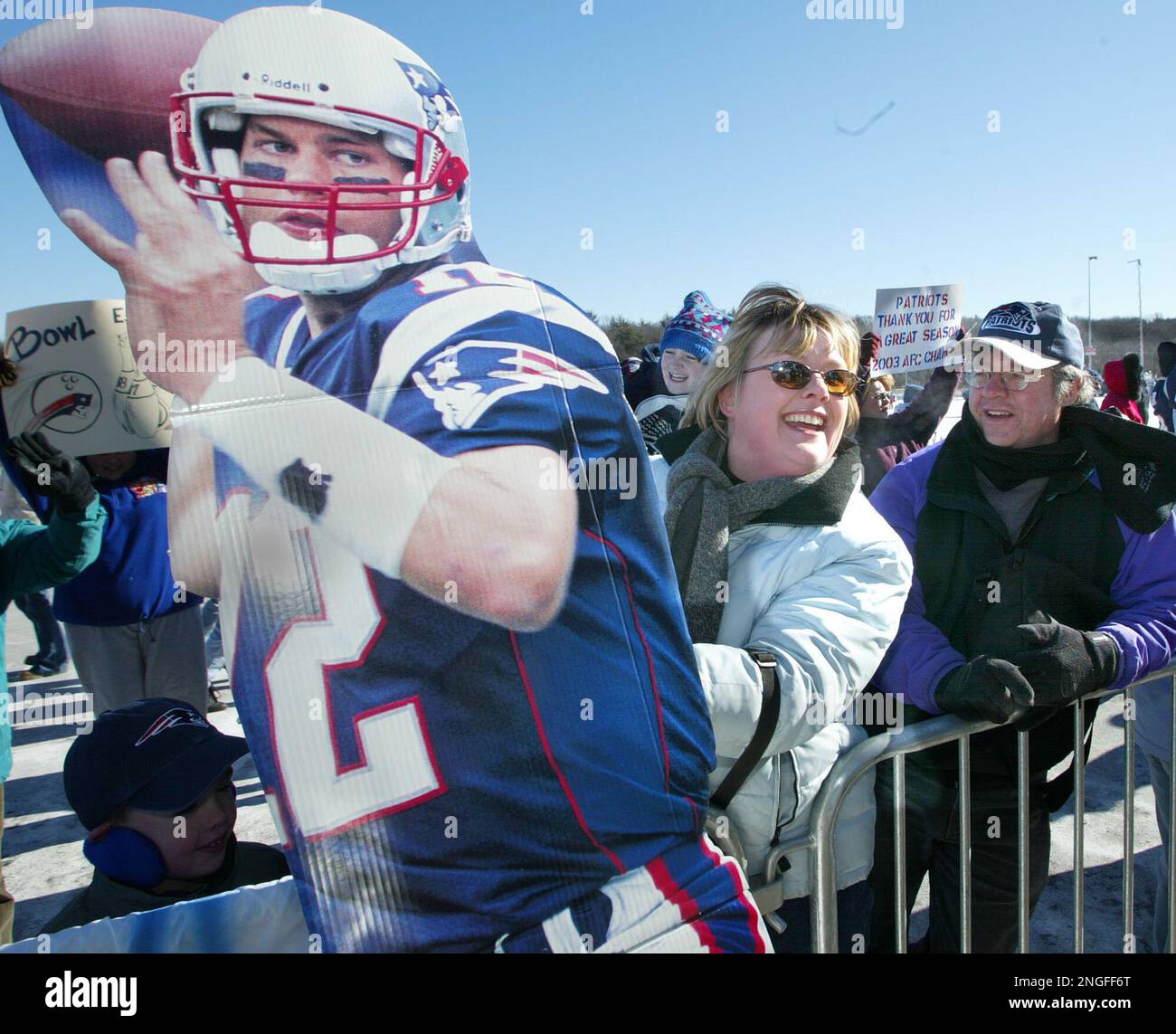 New England Patriots fan Kristen Liddell of Milton, Mass. holds cardboard image of quarterback Tom Brady during a pep rally for the Super Bowl bond Patriots at Gillette Stadium in Foxboro, Mass., Sunday, Jan. 25 2004, en route to Houston, Texas. The Patriots will face the North Carolina Panthers in Super Bowl XXXVIII on Feb. 1. (AP Photo/Jim Rogash) Stock Photo