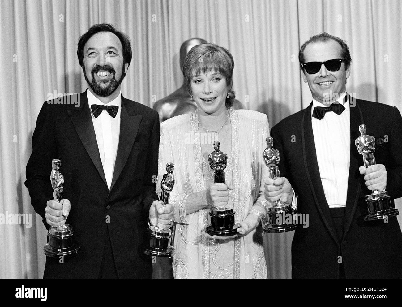 Actress Shirley MacLaine is flanked by director James L. Brooks, left