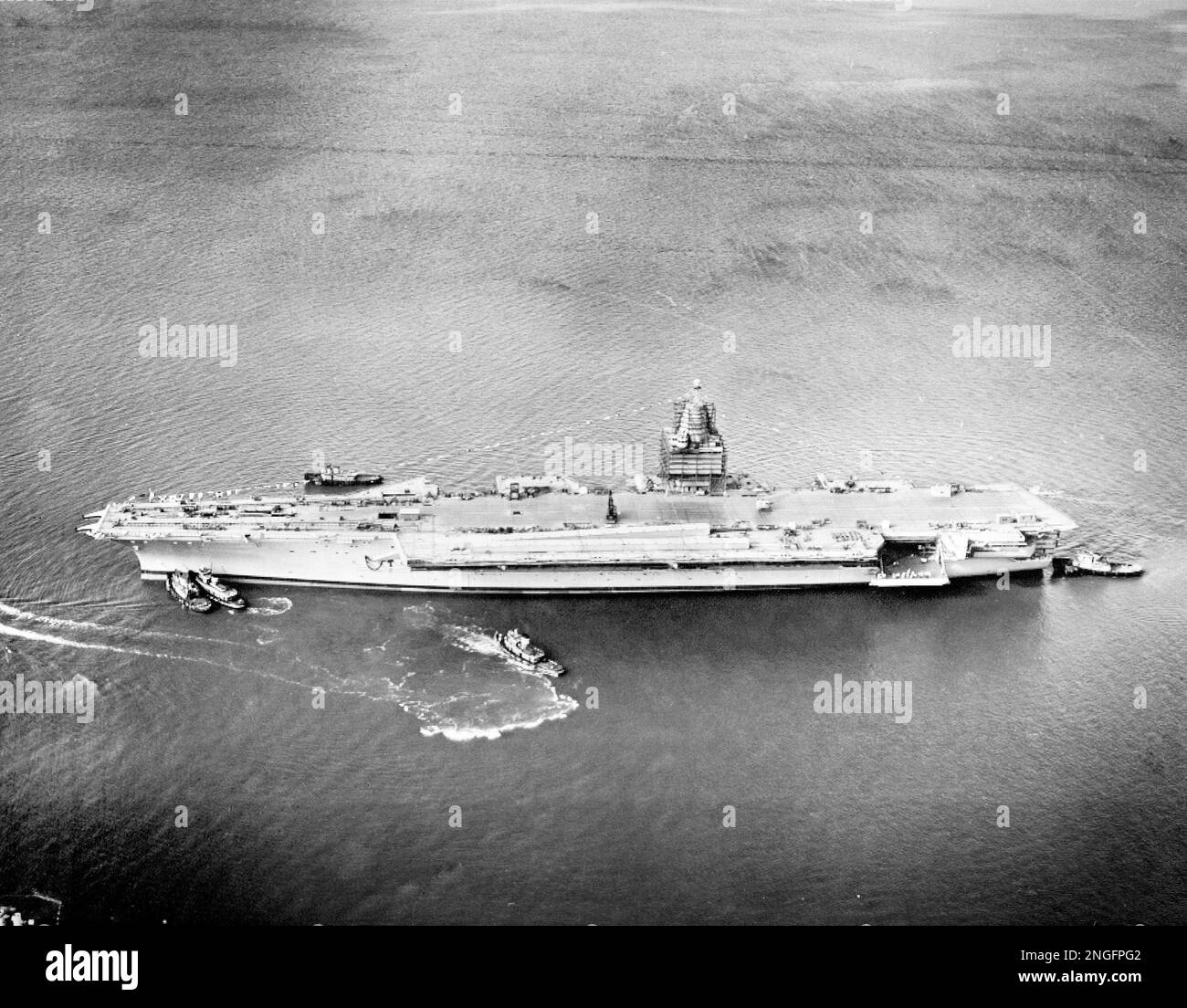 The 85000ton atomic aircraft carrier Enterprise is moved by tug boats