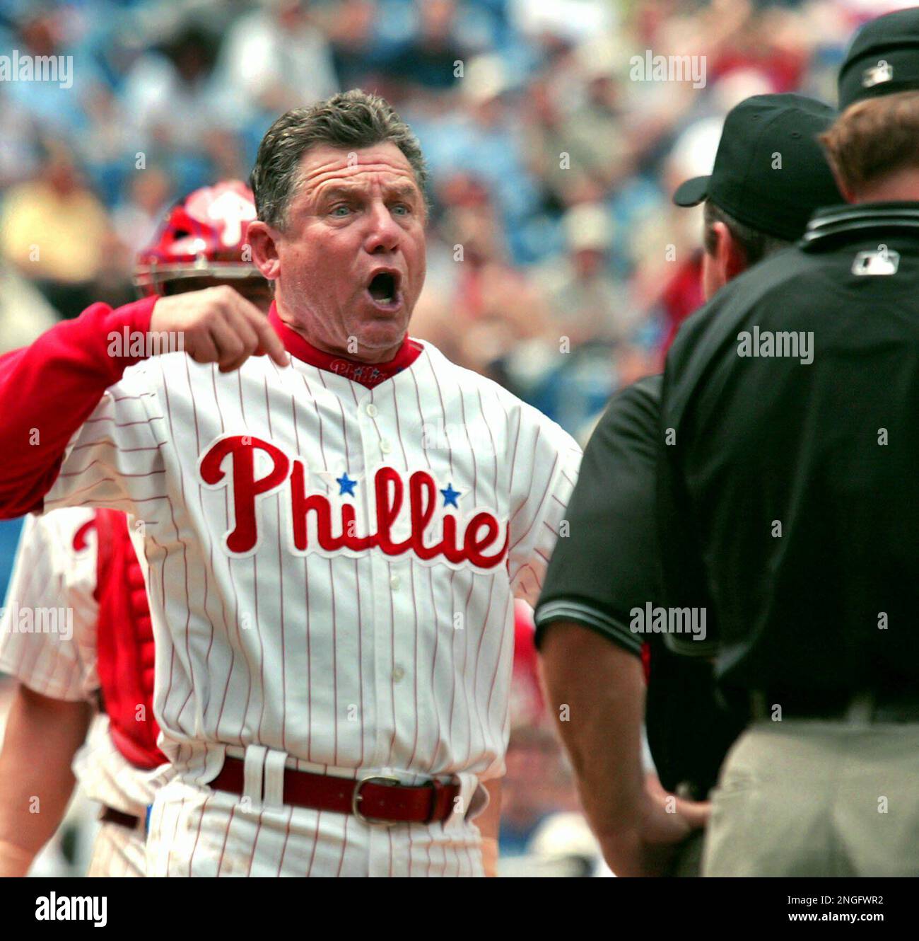 Philadelphia Phillies manager Larry Bowa yells at umpires Terry Craft, far right, and Charlie Reliford after he was ejected with one out in the top of the ninth inning against the Atlanta Braves, for arguing balls and strikes with plate umpire Craft, Thursday, June 19, 2003, in Philadelphia. Bowa was tossed after a 1-2 pitch by Mesa on Javy Lopez. The Phillies won 3-2 on a Jimmy Rollins RBI single. (AP Photo/George Widman) Stock Photo