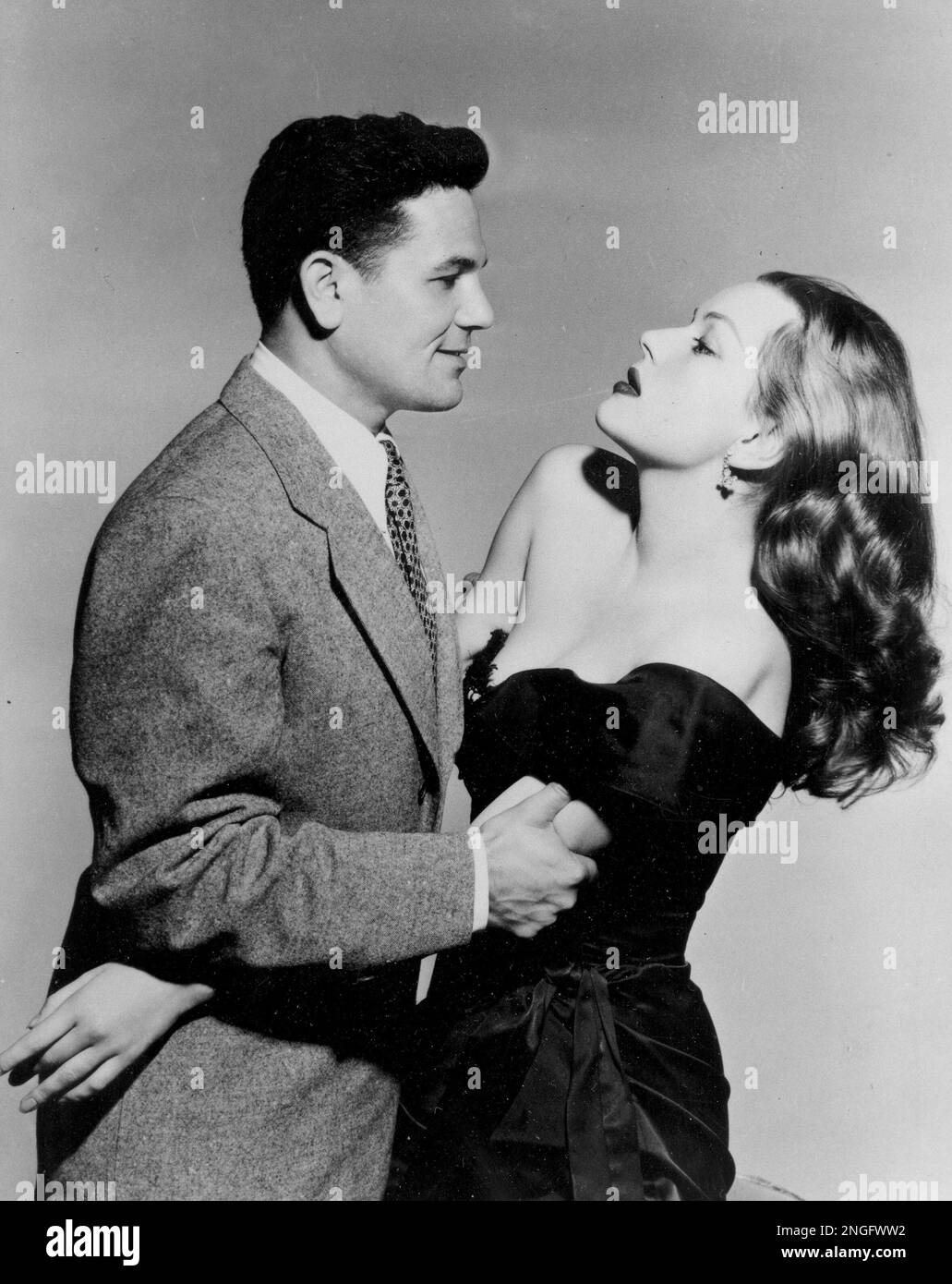 Actor John Garfield and actress Hazel Brooks pose in a scene from the