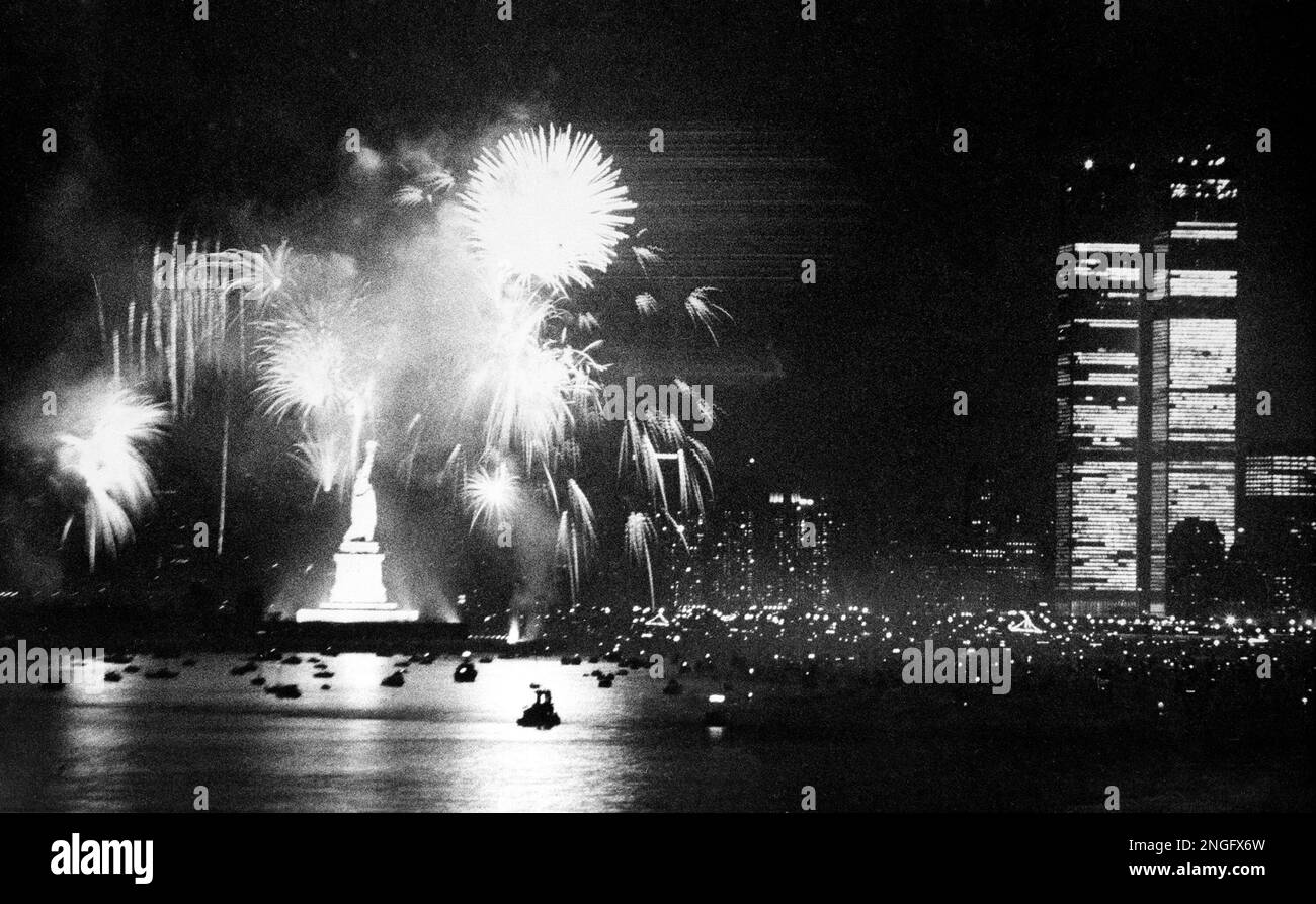 Seen from the New Jersey shore, fireworks at the Statue of Liberty