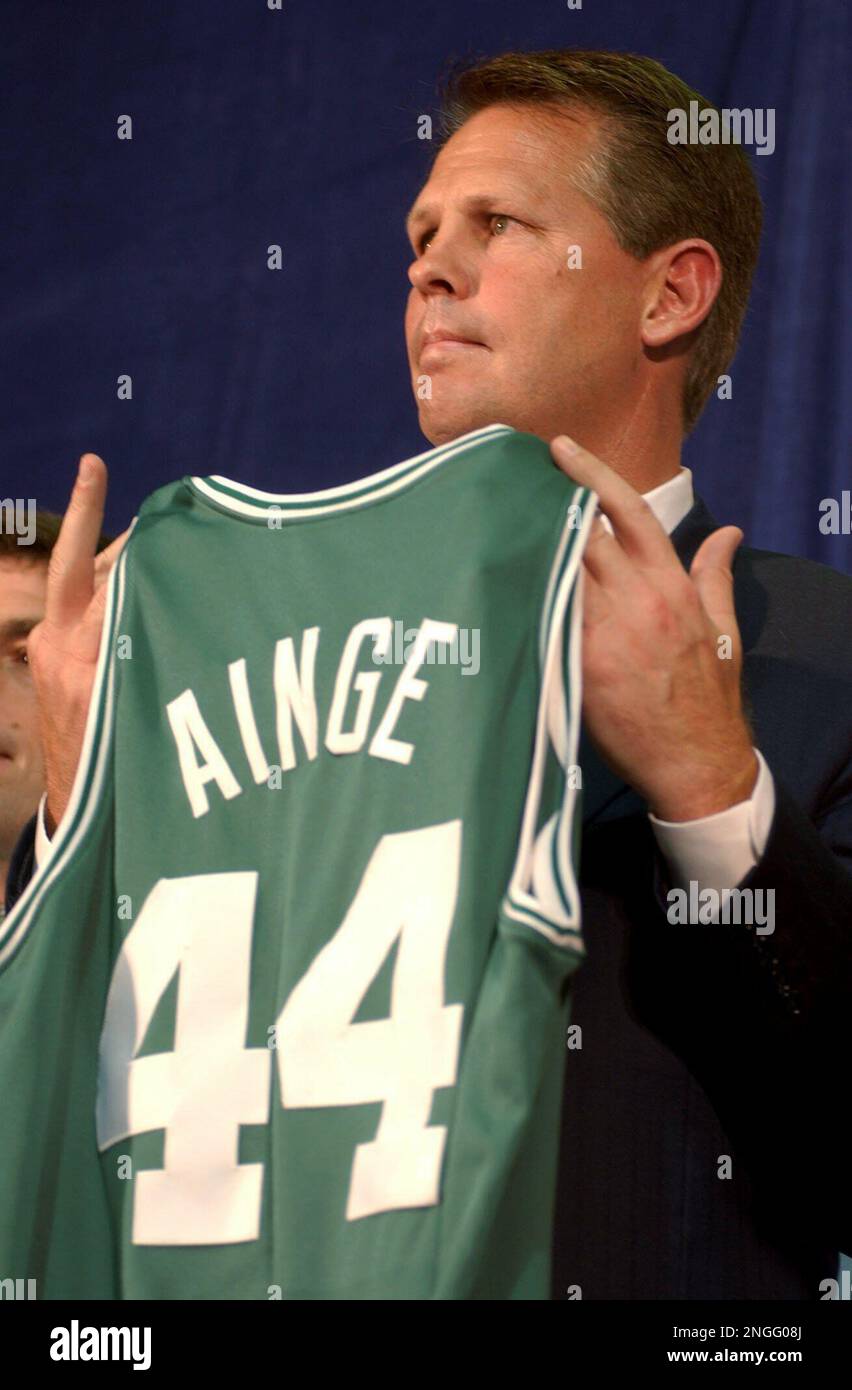 Danny Ainge holds up a Celtics jersey bearing his old number during a news  conference Friday, May 9, 2003, in Boston. Ainge, who played for the Celtics  from 1981-89 and was on