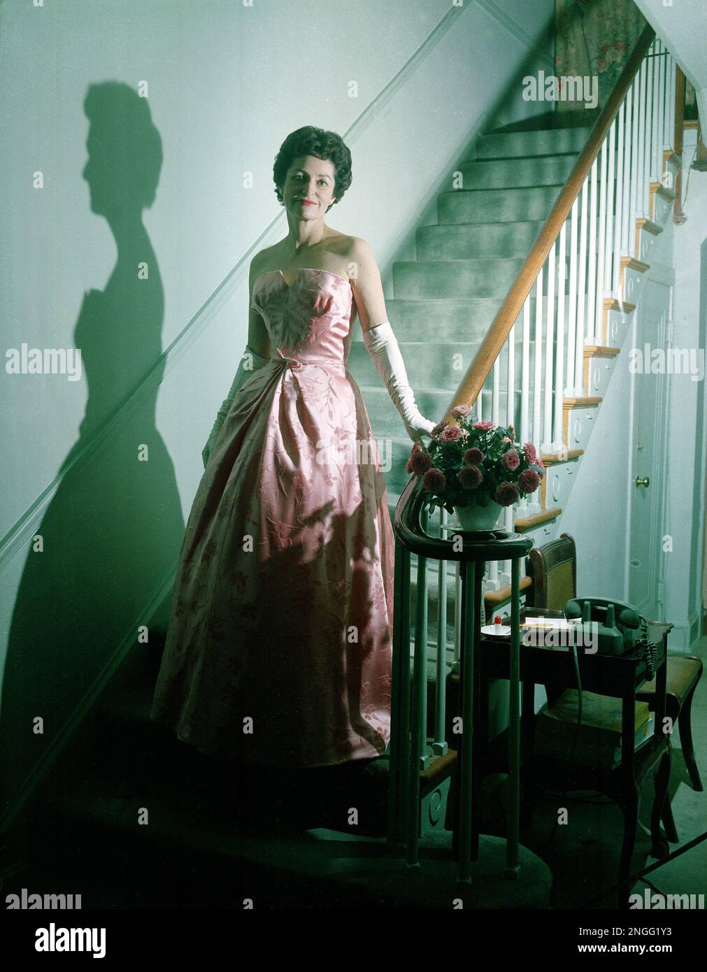 Lady Bird Johnson, wife of designated Vice President Lyndon B. Johnson, poses in the evening gown she plans to wear at the inauguration ball for President-elect John F. Kennedy, at her home Lady Bird Johnson, wife of designated Vice President Lyndon B. Johnson, poses in the evening gown she plans to wear at the inauguration ball for President-elect John F. Kennedy, at her home