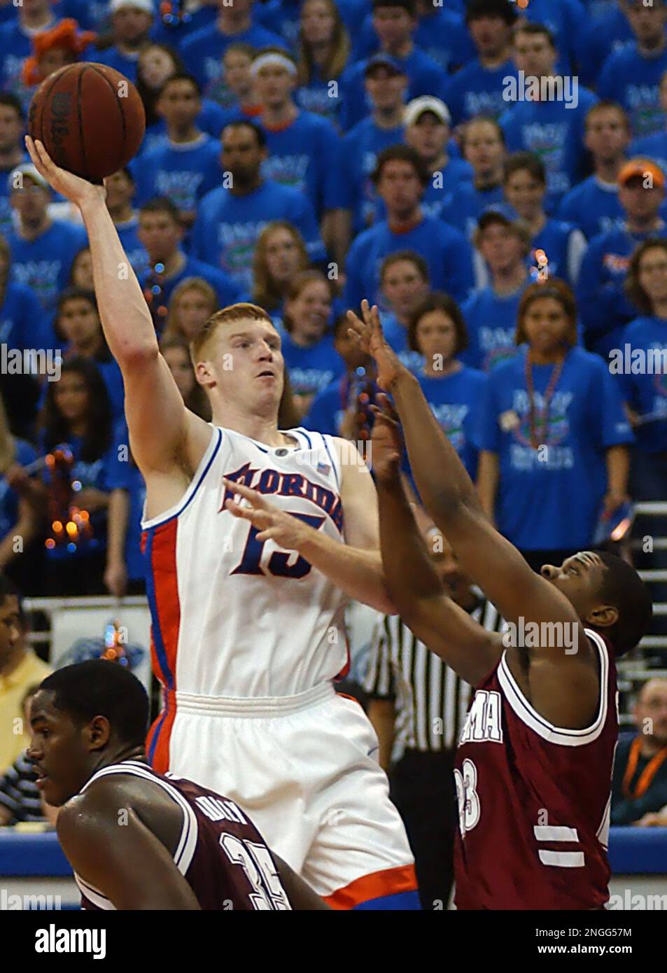 Florida's Matt Bonner (15) shoots for three points as Alabama's Demetrius  Smith, right, and Erwin Dudley defend during the second half in  Gainesville, Fla., Saturday, Feb. 8, 2003. Bonner was game-high scorer, image size:953x1390