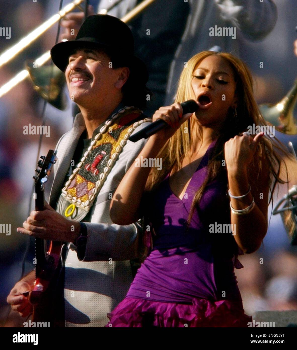 Carlos Santana left and Beyonce Knowles entertain the crowd prior to the start of Super Bowl XXXVII between the Oakland Raiders and Tampa Bay Buccaneers in San Diego Calif. Sunday Jan. 26