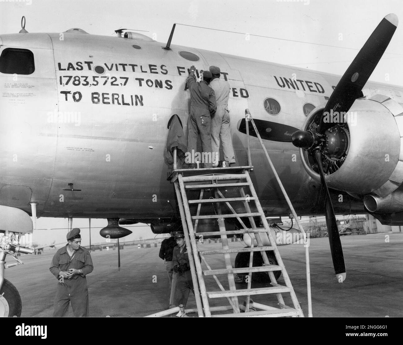 Maintenance crew paint the total tonnage number on the last C 54