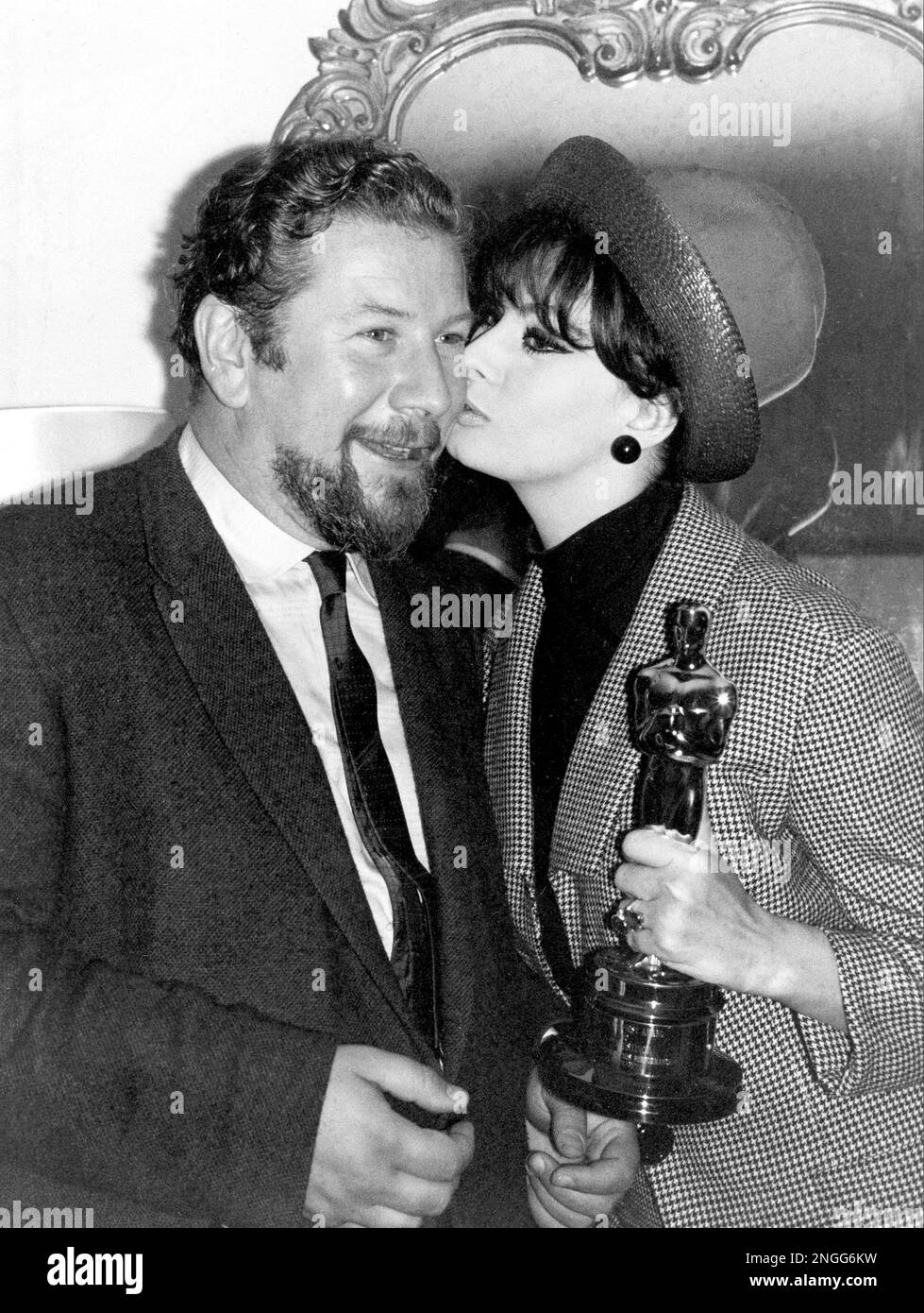 Actor Peter Ustinov gets a kiss from Italian actress Sophia Loren as