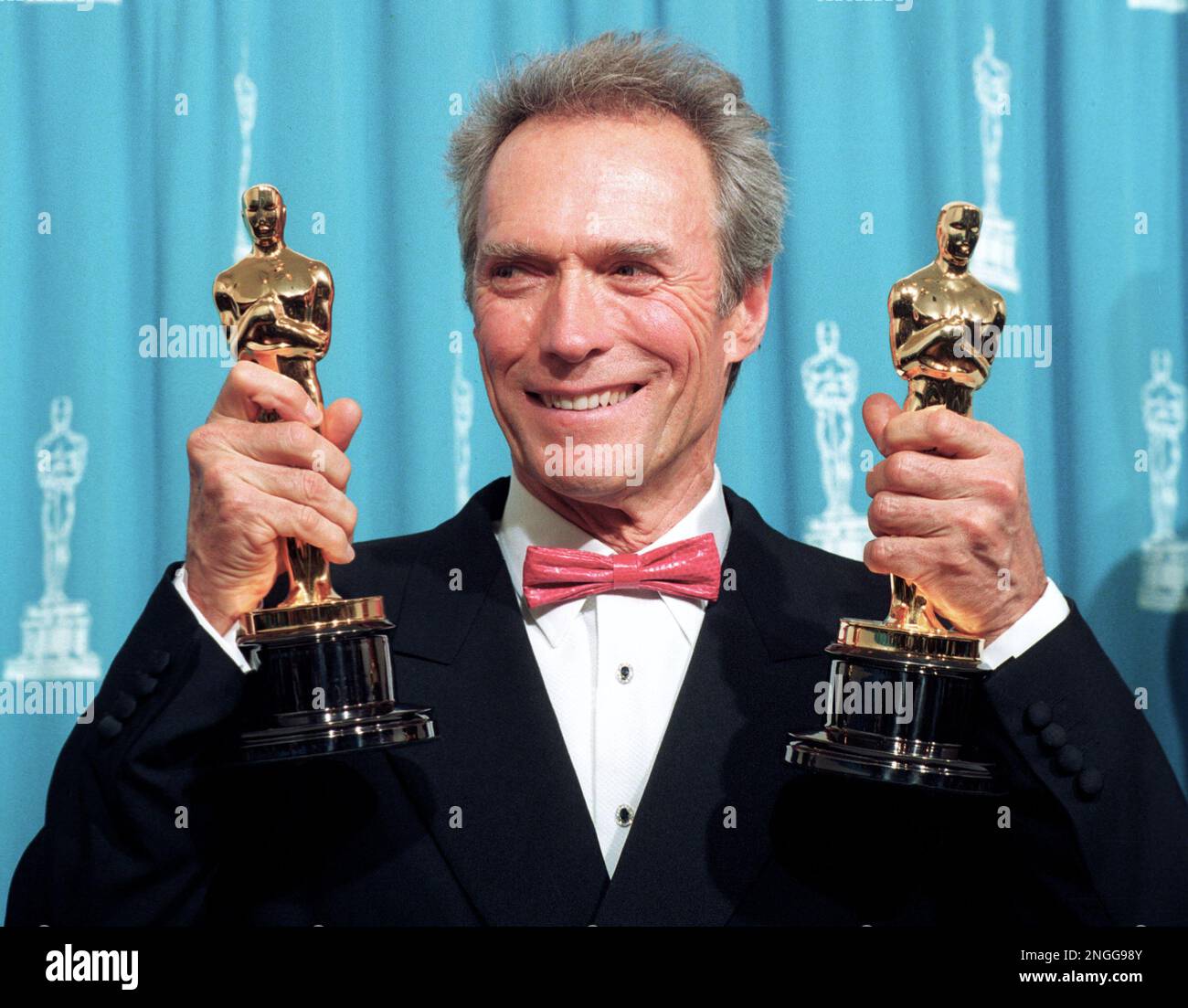 Clint Eastwood holds up his two Oscars at the Academy Awards in Los