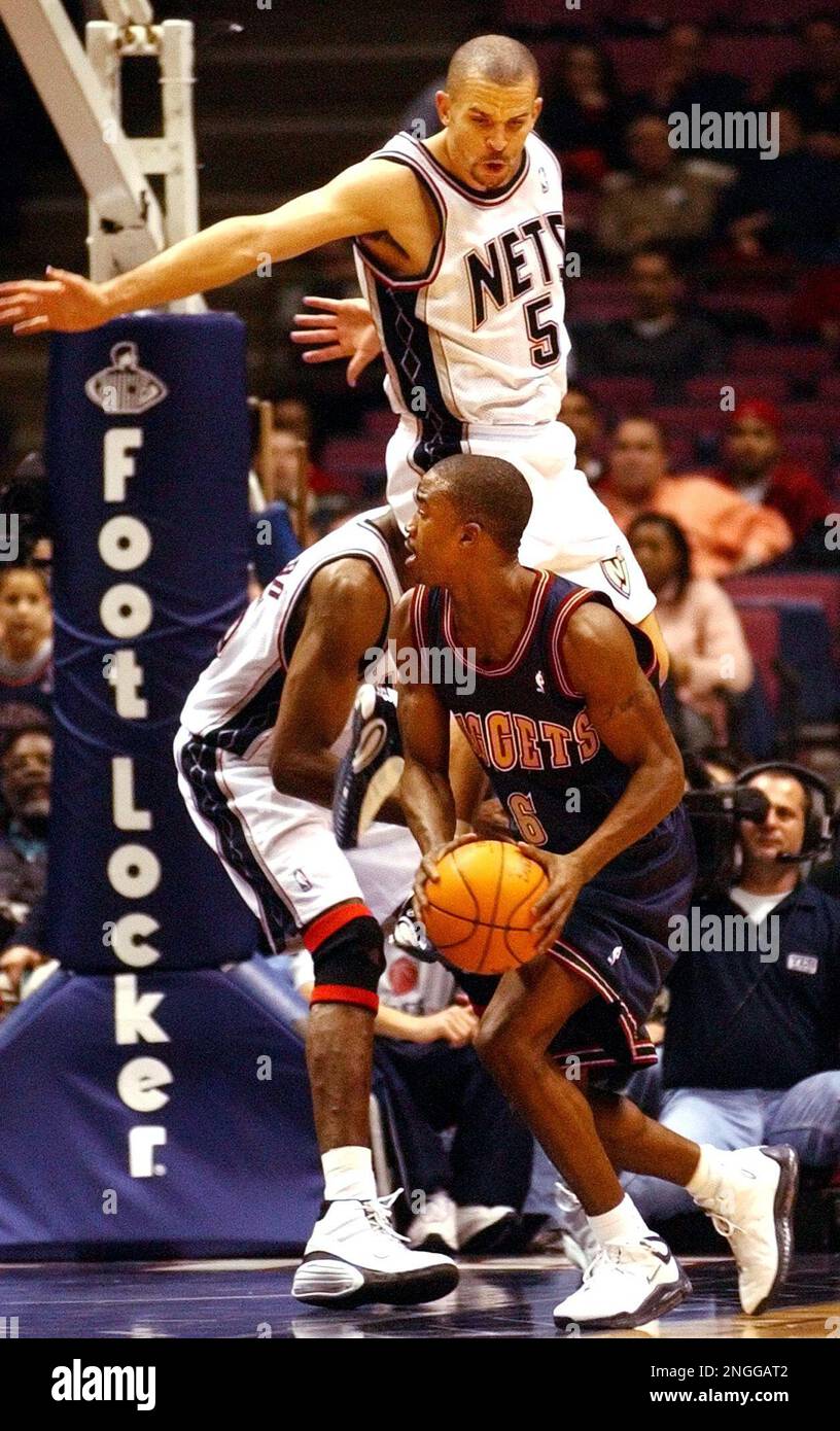 New Jersey Nets' Jason Kidd (5) and Dikembe Mutombo double-team Denver  Nuggets' Junior Harrington during the third quarter Monday night, Nov. 18,  2002, in East Rutherford, N.J. The Nets won 99-79. (AP