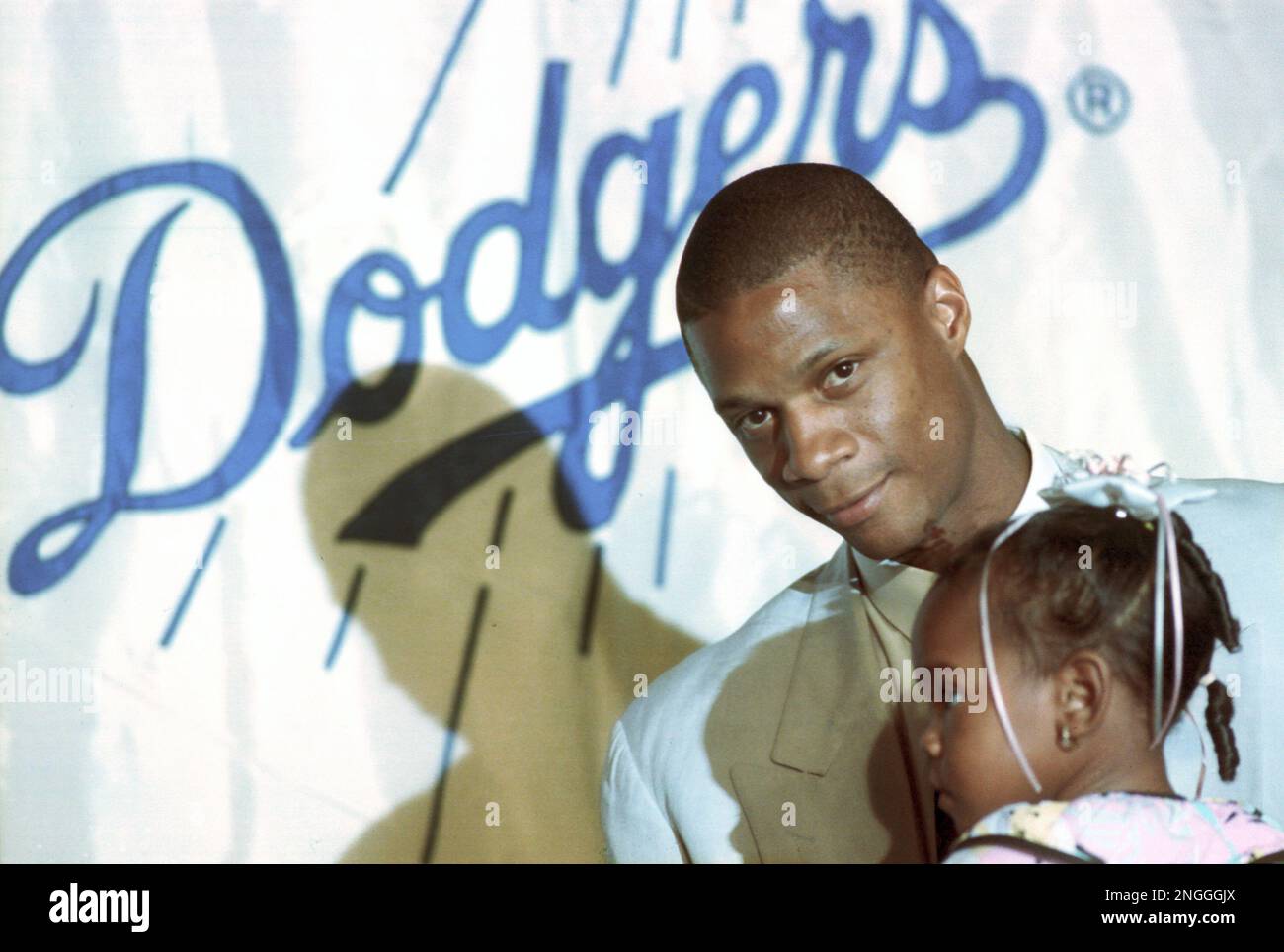 Darryl Strawberry of the Los Angeles Dodgers is shown with his two-year-old  daughter Diamond at a news conference in Los Angeles, Ca., Nov. 9, 1990.  Strawberry signed a five-year $20.3 million contract