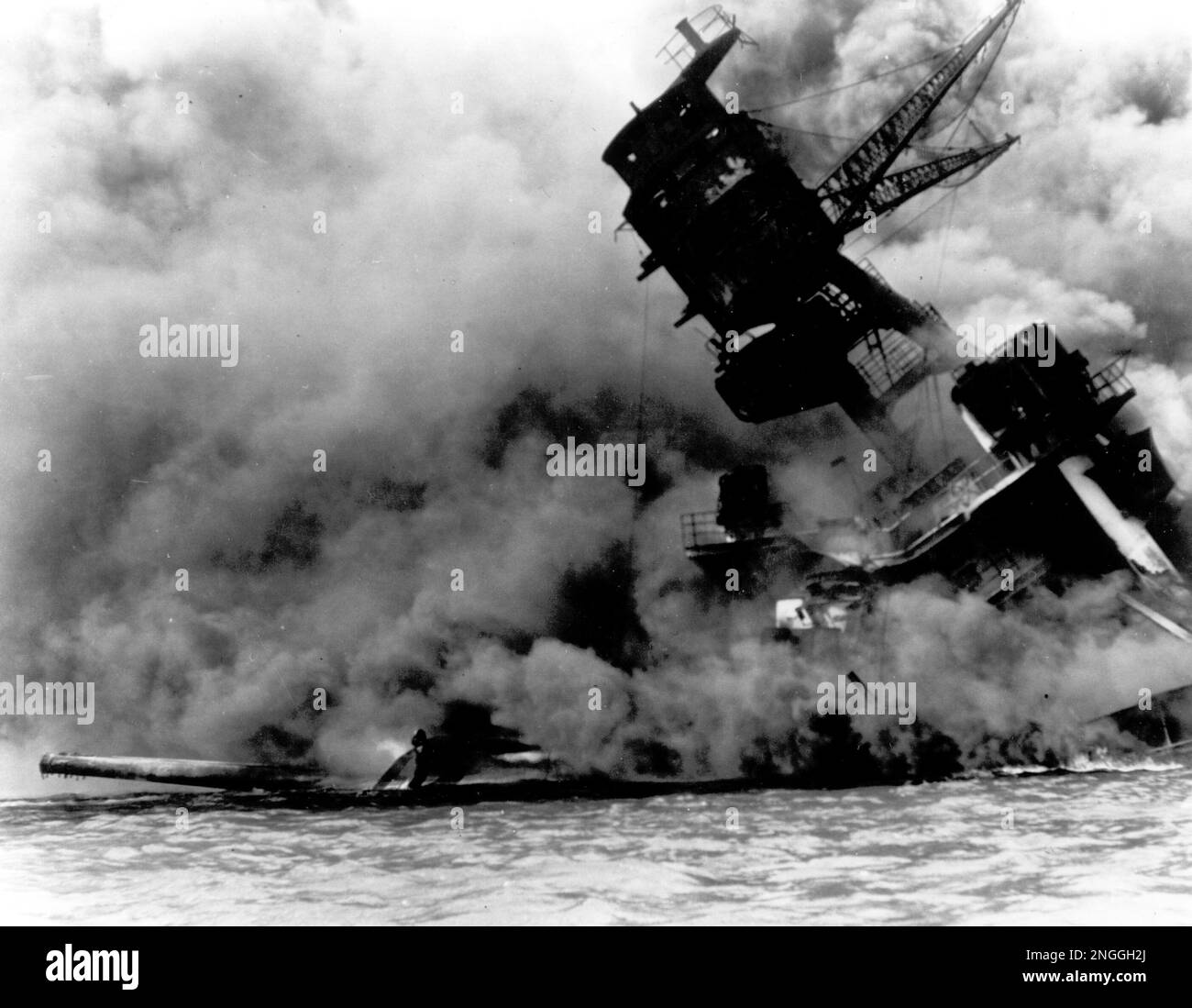 The sinking battleship USS Arizona begins to sink into the sea after