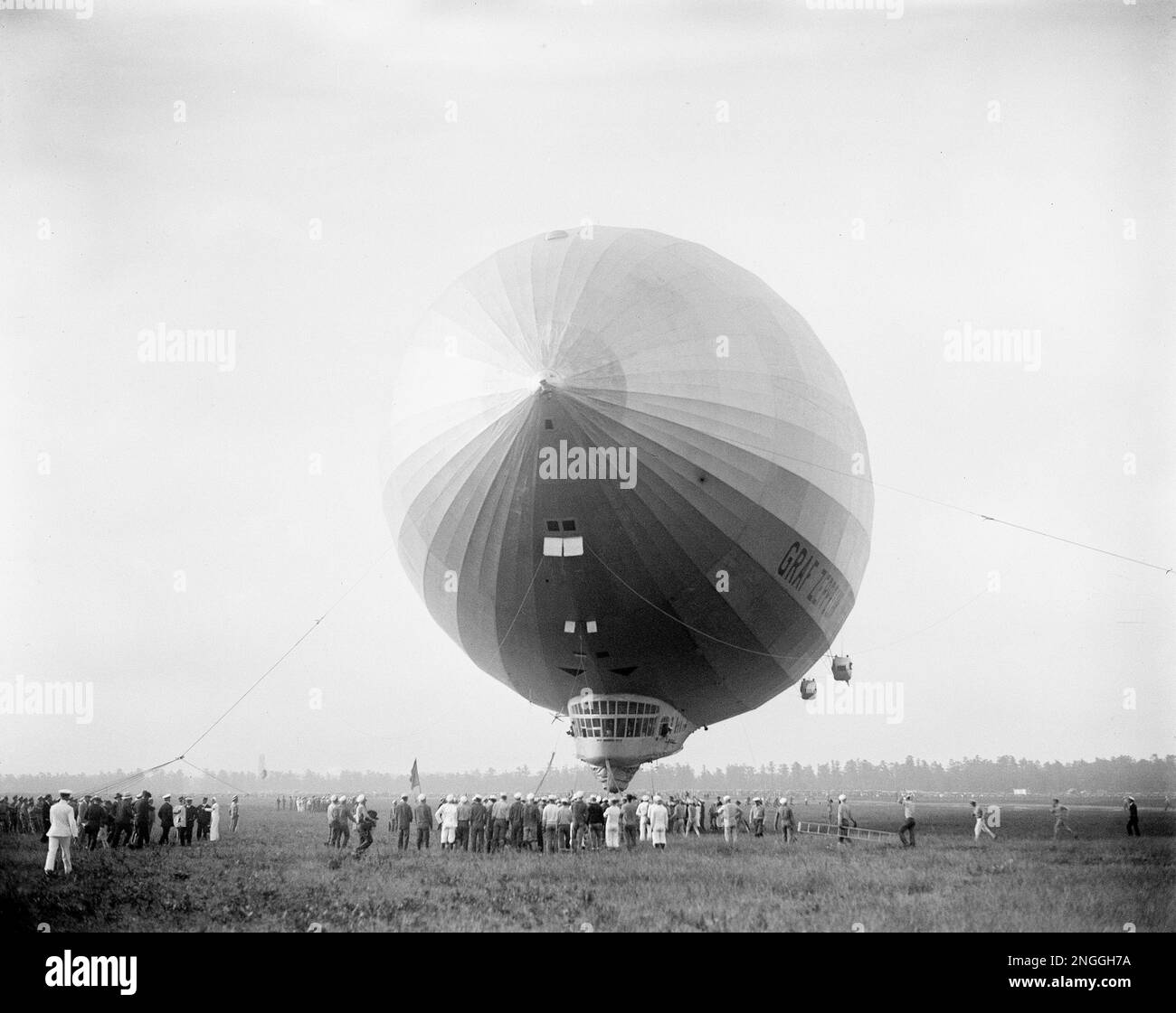 The giant German dirigible Graf Zeppelin is being pulled down from the ...