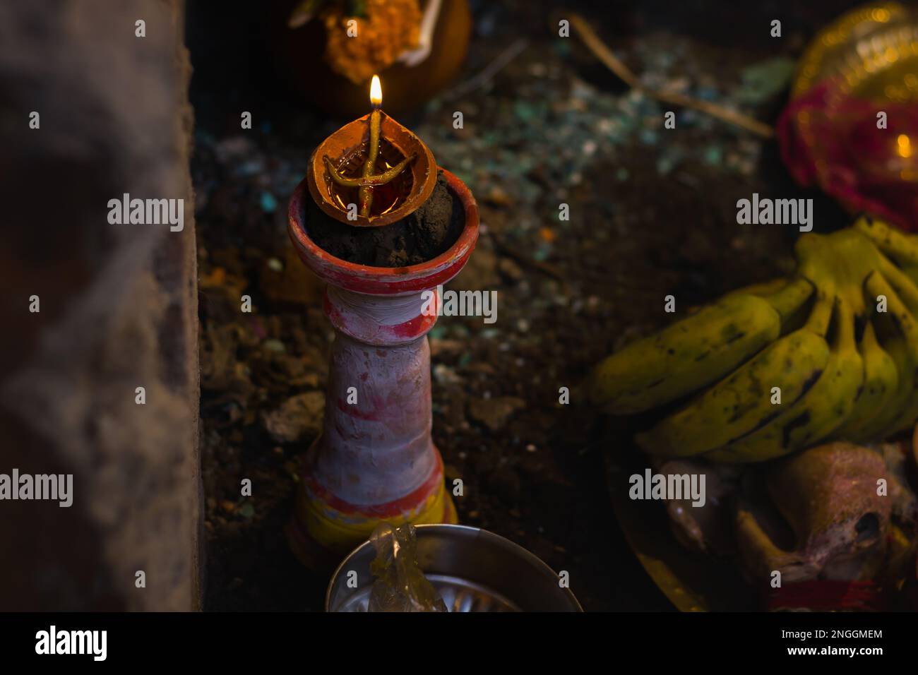 Clay lamp on pilsuj stand burning with yellow flame illuminated for ...