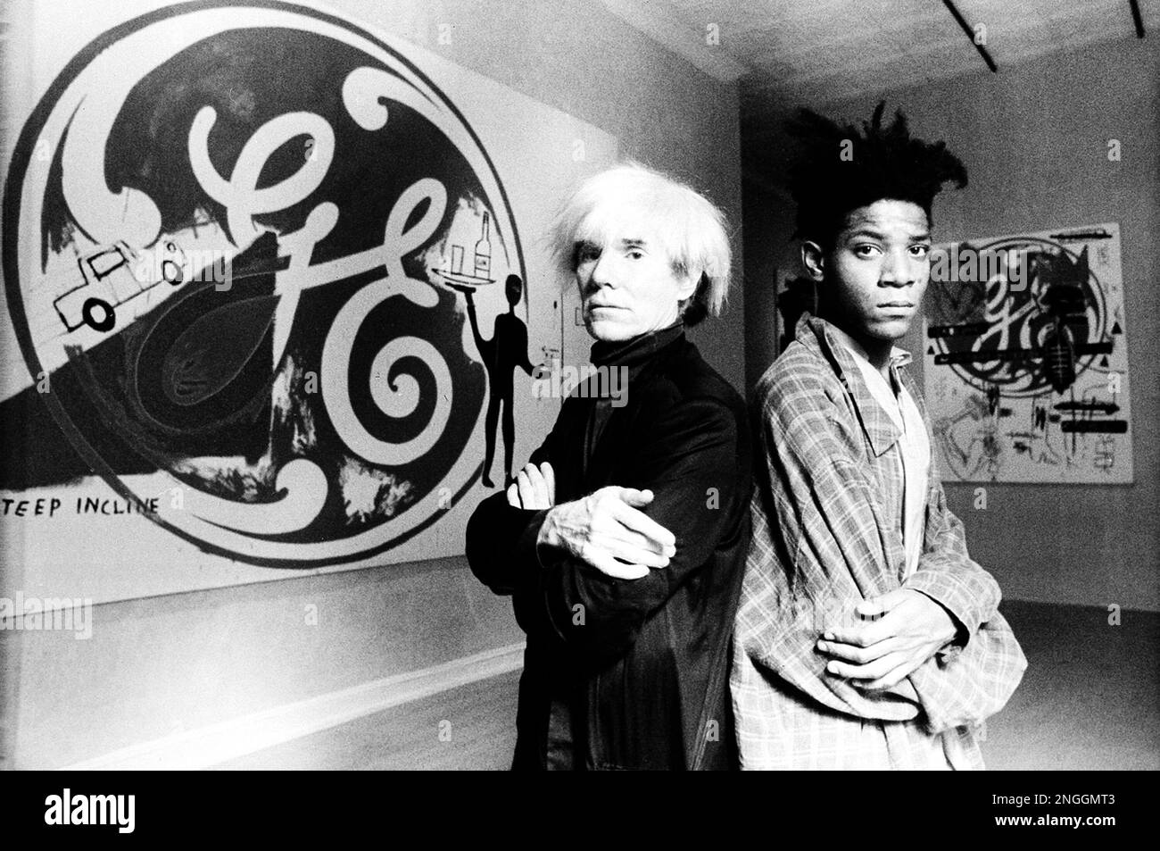Pop artist Andy Warhol, left, poses with artist Jean-Michel