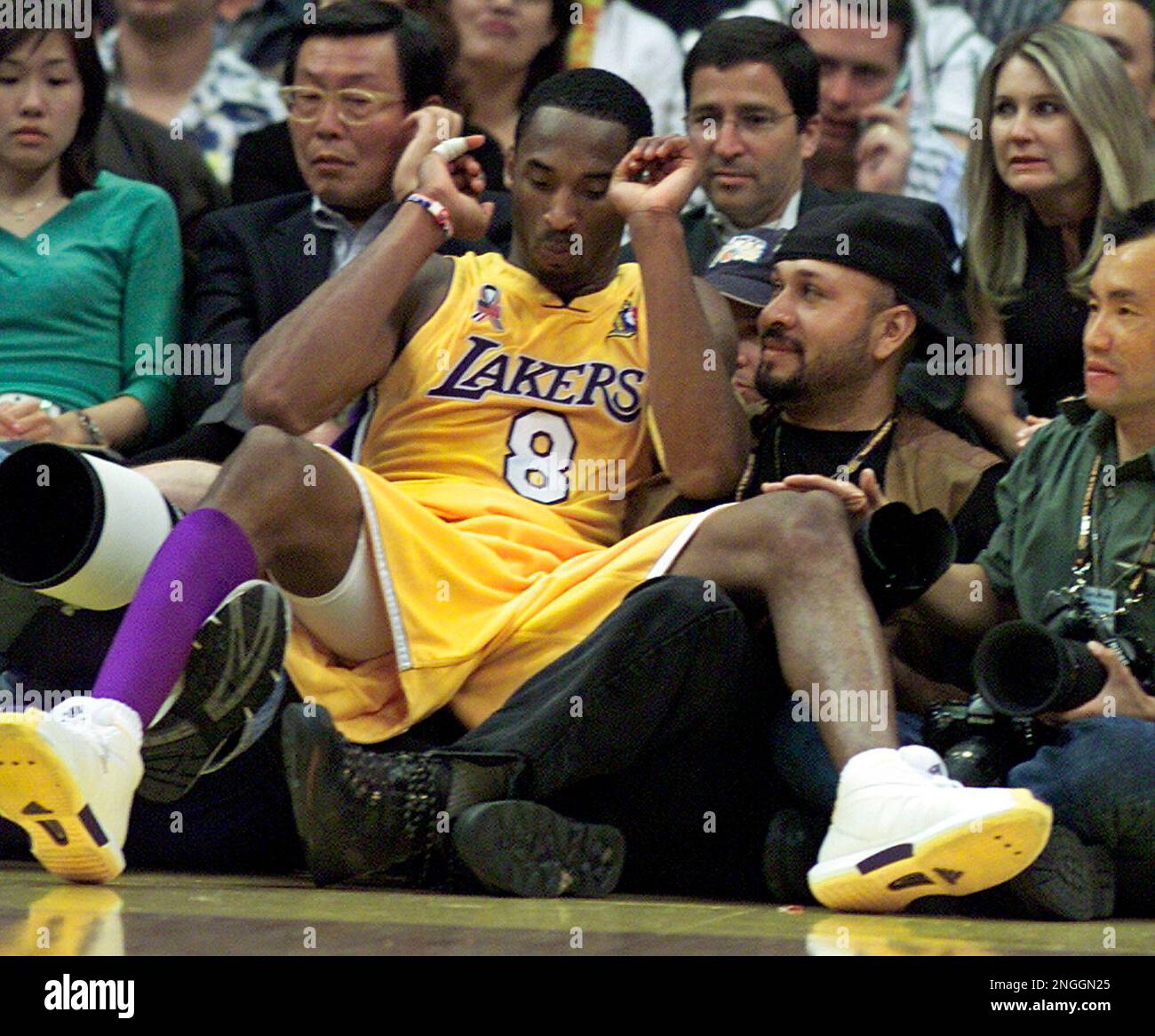 Los Angeles Lakers Kobe Bryant lands in the lap of Riverside  Press-Enterprise photographer Carlos Puma in the fourth quarter against the  New Jersey Nets in Game 1 of the NBA Finals Wednesday,