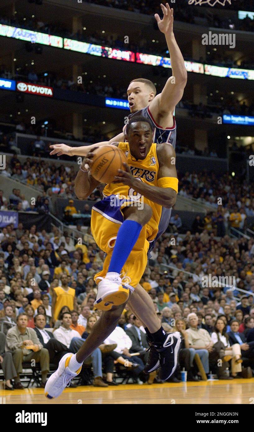 Los Angeles Lakers' Kobe Bryant drives to the basket past New Jersey Nets'  Aaron Williams during the first quarter in Game 1 of the NBA Finals  Wednesday, June 5, 2002, in Los