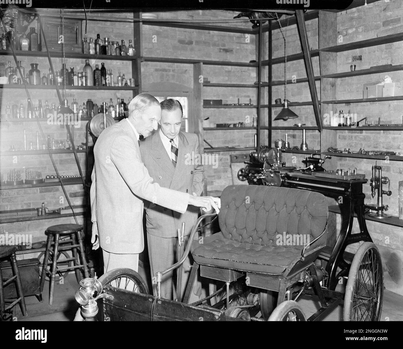Industrialist Henry Ford and his son, Edsel, inspect the first