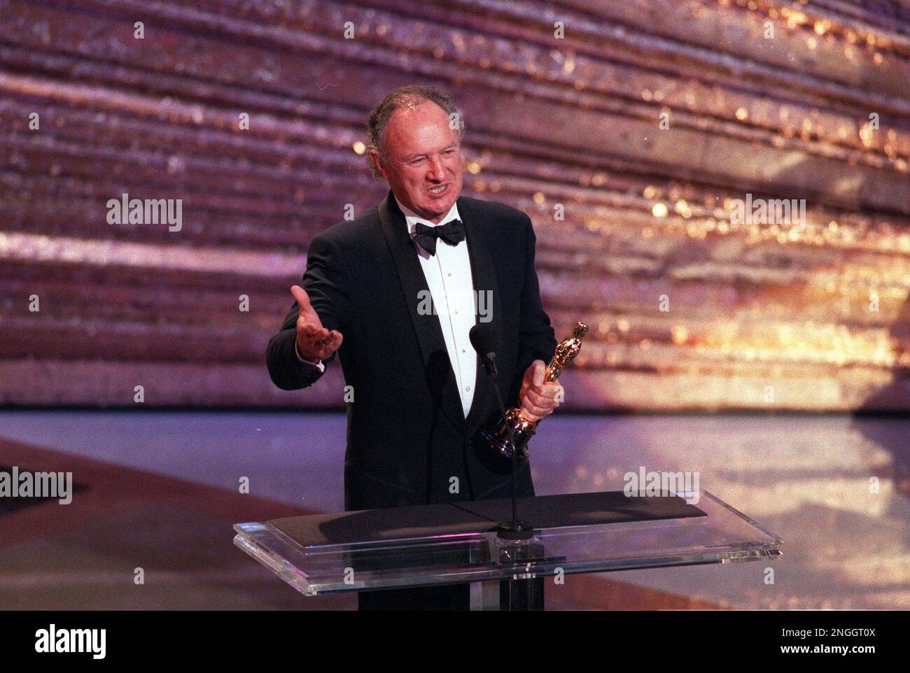 Gene Hackman accepts his best supporting Oscar for his role in