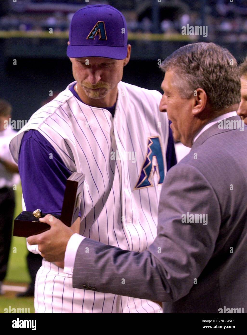 Arizona Diamondbacks owner Jerry Colangelo, left, presents pitcher Randy  Johnson with his third consecutive Cy Young award prior to the Diamondbacks  match-up against the San Diego Padres Wednesday, April 3, 2002 at