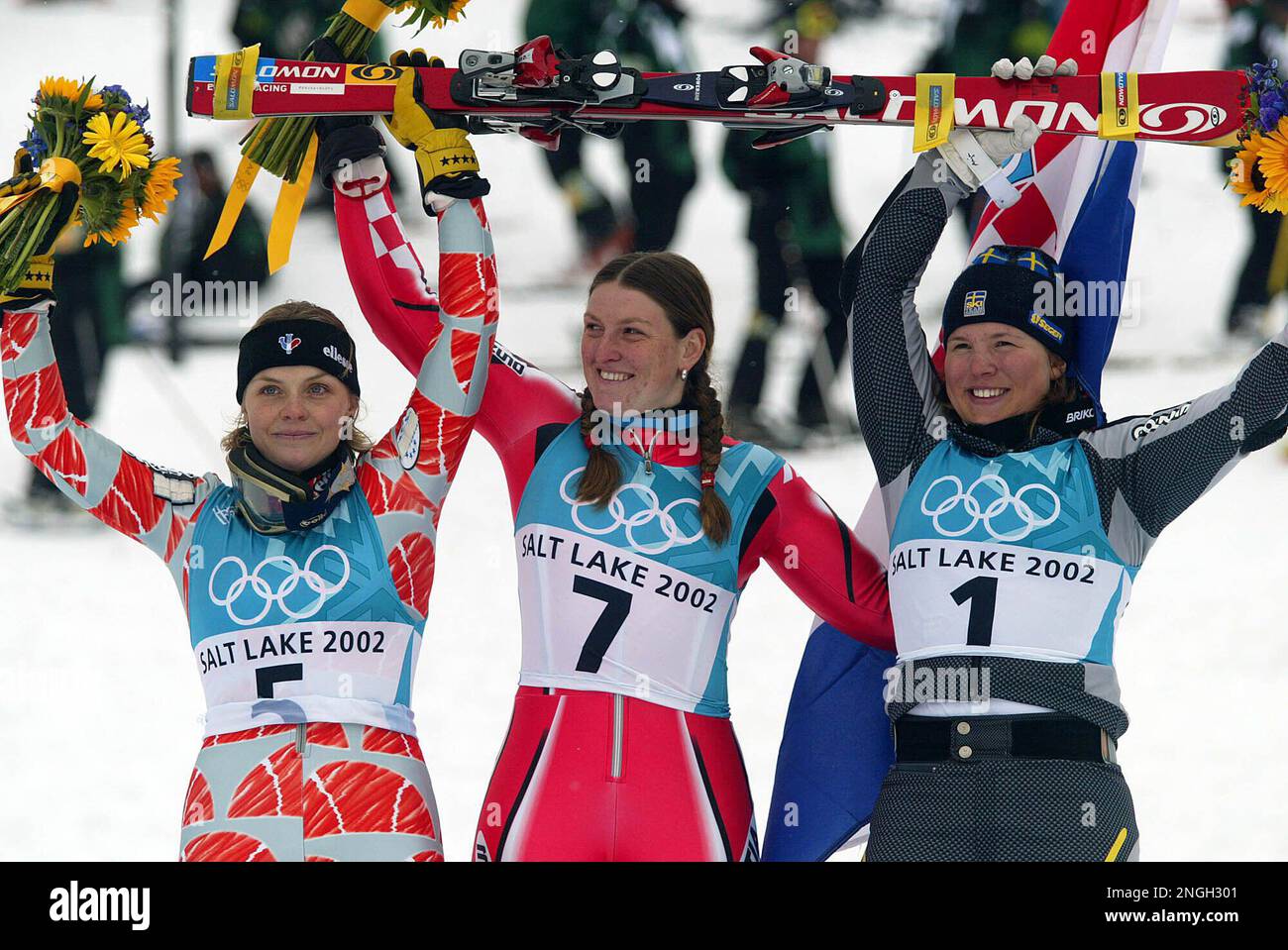 Croatia's Janica Kostelic, center, celebrates with Laura Pequegnot of France, left, and Anja Paerson of Sweden, right, at the end of the Women's Slalom at the Salt Lake City Winter Olympic Games in Deer Valley, Utah Wednesday Feb. 20, 2002. Kostelic won the gold medal, Pequegnot the silver and Paerson the bronze. (AP Photo/Thomas Kienzle) Stock Photo