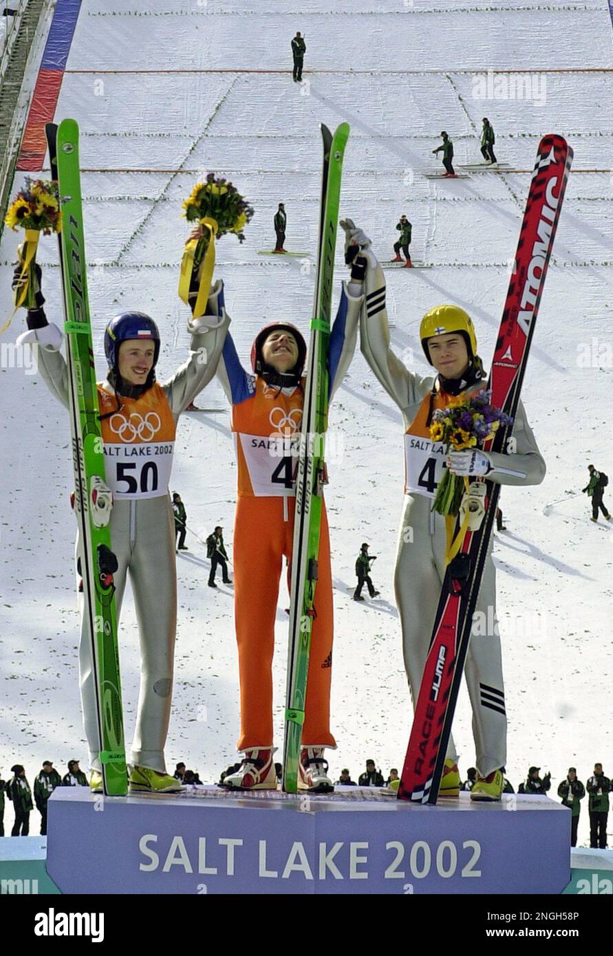 Simon Ammann of Switzerland, center, reacts during the flower ceremony  after he won the gold medal in the Individual K120 ski jump at the 2002  Salt Lake City Winter Olympics in Park