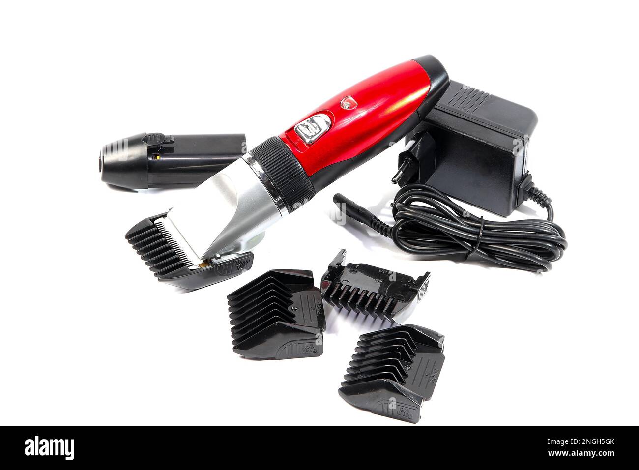 Hair clipper, attachments of different sizes, extra battery, charger in