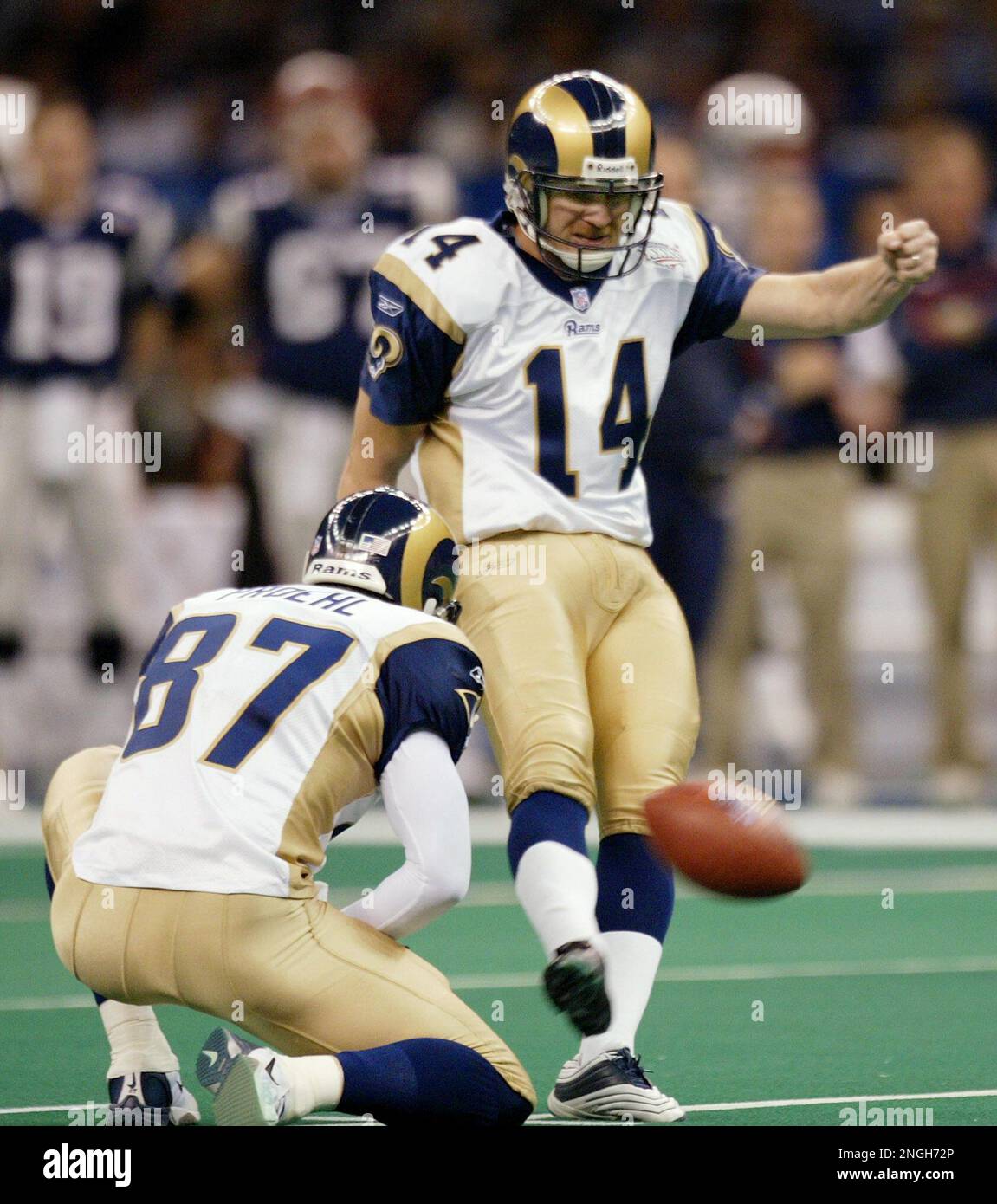 St. Louis Rams kicker Jeff Wilkins (14) boots a 50-yard field goal out of the hold of Ricky Proehl (87) in the first quarter of Super Bowl XXXVI against the New England Patriots Sunday, Feb. 3, 2002, in New Orleans. (AP Photo/Rusty Kennedy) Stock Photo