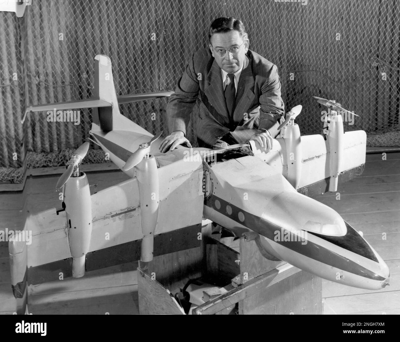 Aeronautical engineer Charles Zimmerman poses with a model of a tilt