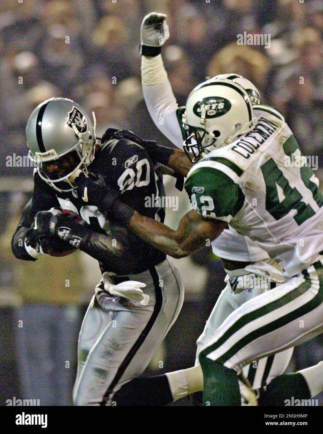 New York Jets' Victor Green (21) and Aaron Glenn (31) wrap up