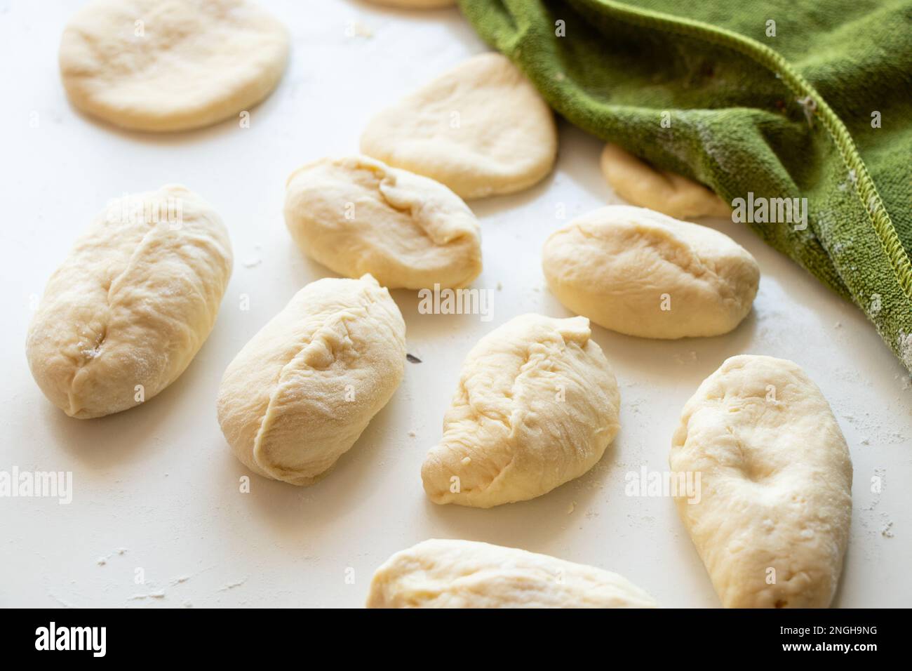 raw pies with potatoes on a white table in the kitchen, homemade pies