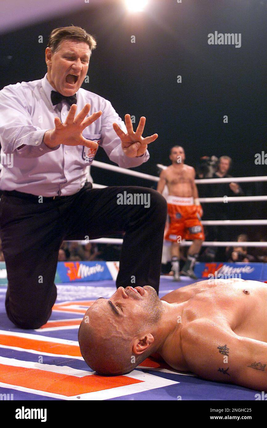 Australian boxer Anthony Mundine is counted out after being knocked out by  Germany's Sven Ottke, background, during a super-middleweight IBF boxing  world championship fight at the Westphalia hall, Saturday, Dec. 1, 2001,