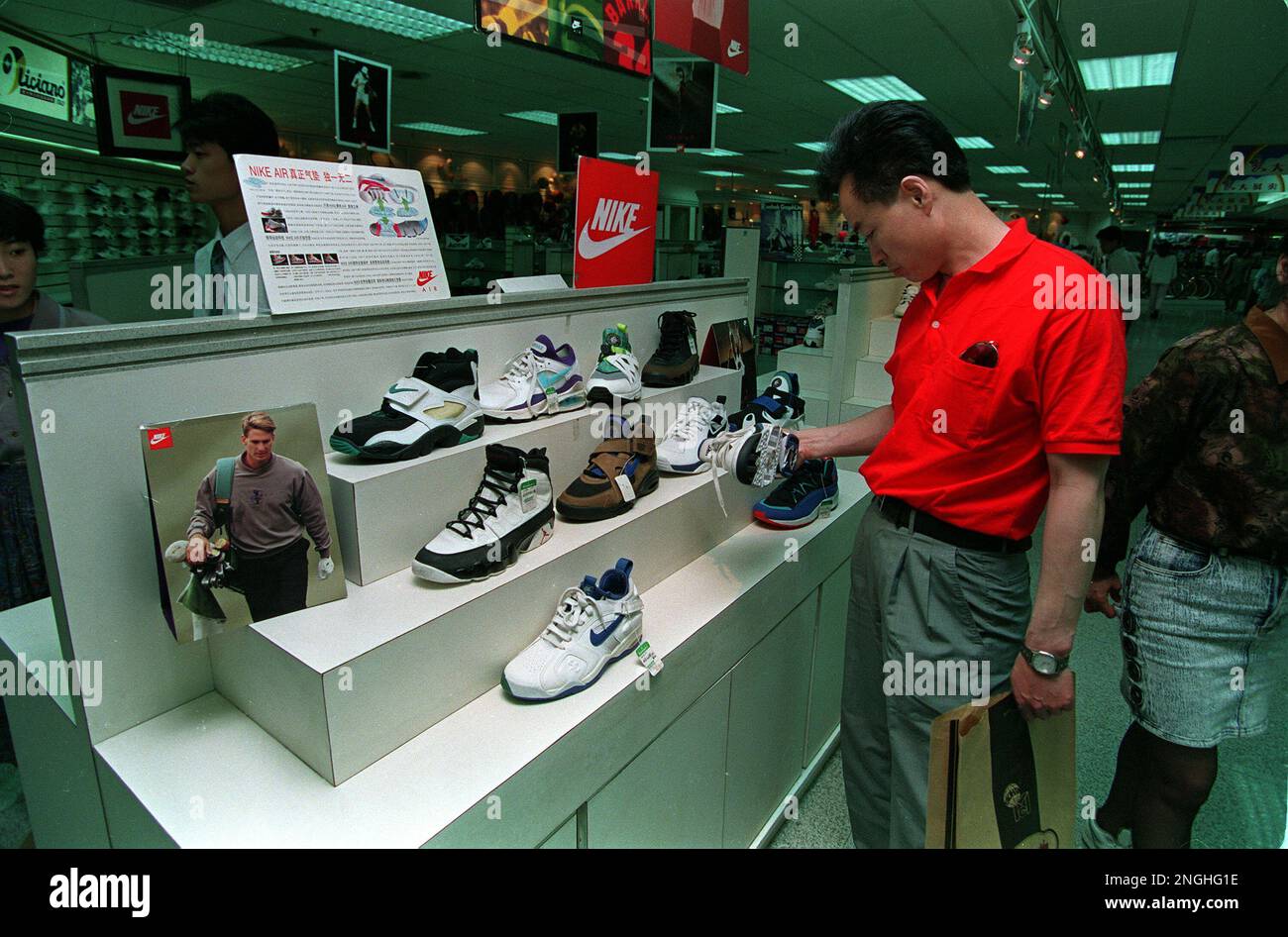 A Chinese shopper looks at Nike shoes on sale in a Beijing department  store, Thursday, May 26, 1994. U.S. President Bill Clinton is expected to  renew the Most Favored Nation trading status