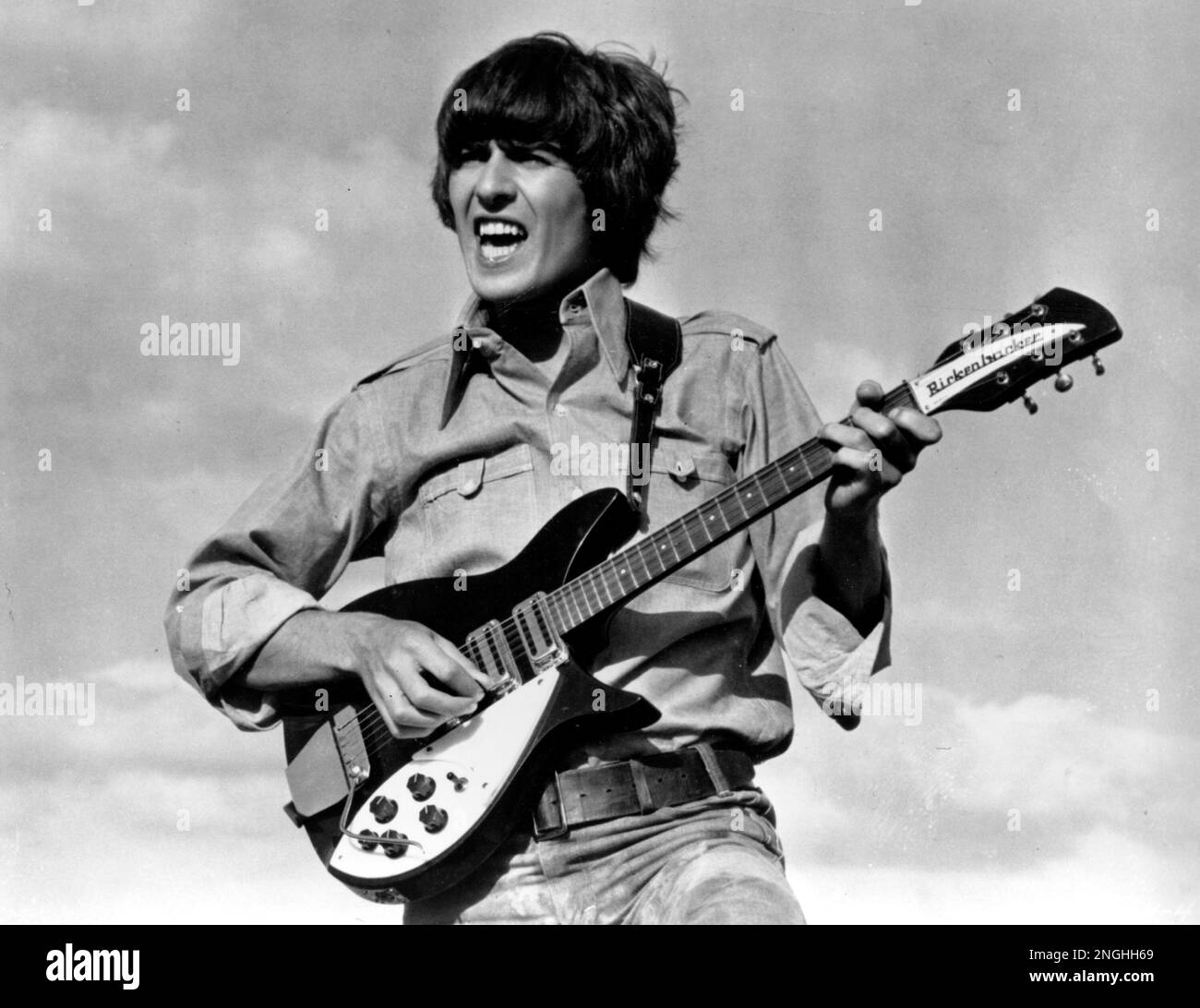 Beatle Harrison is shown playing the guitar in a scene from the