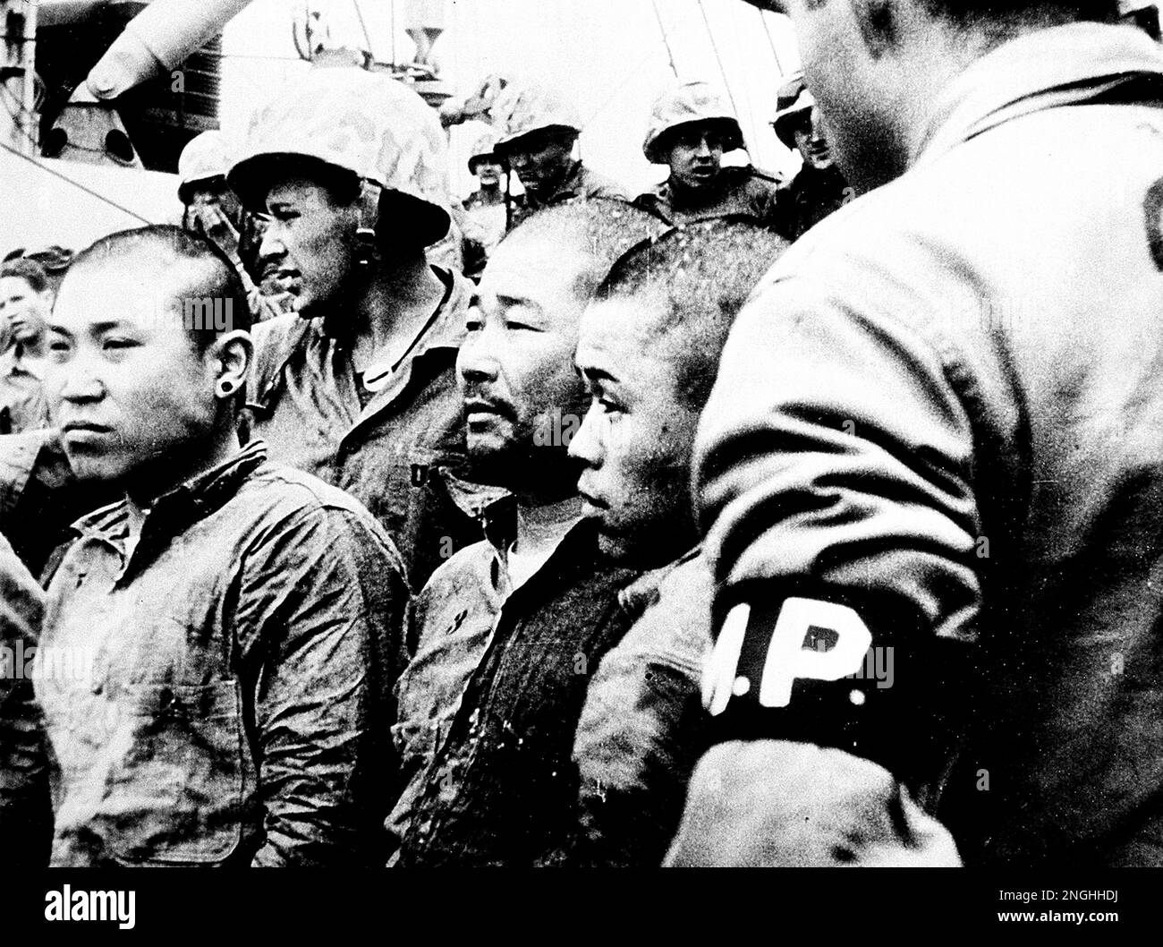 Three Japanese prisoners of war are shown aboard a U.S. Navy vessel in ...