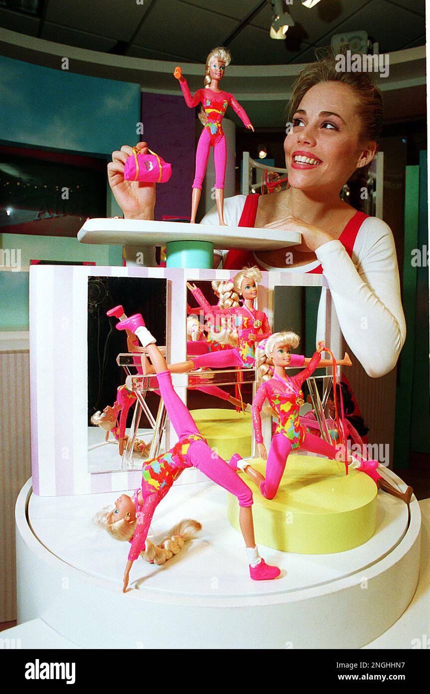Kristin Willets displays several Gymnast Barbie dolls wearing