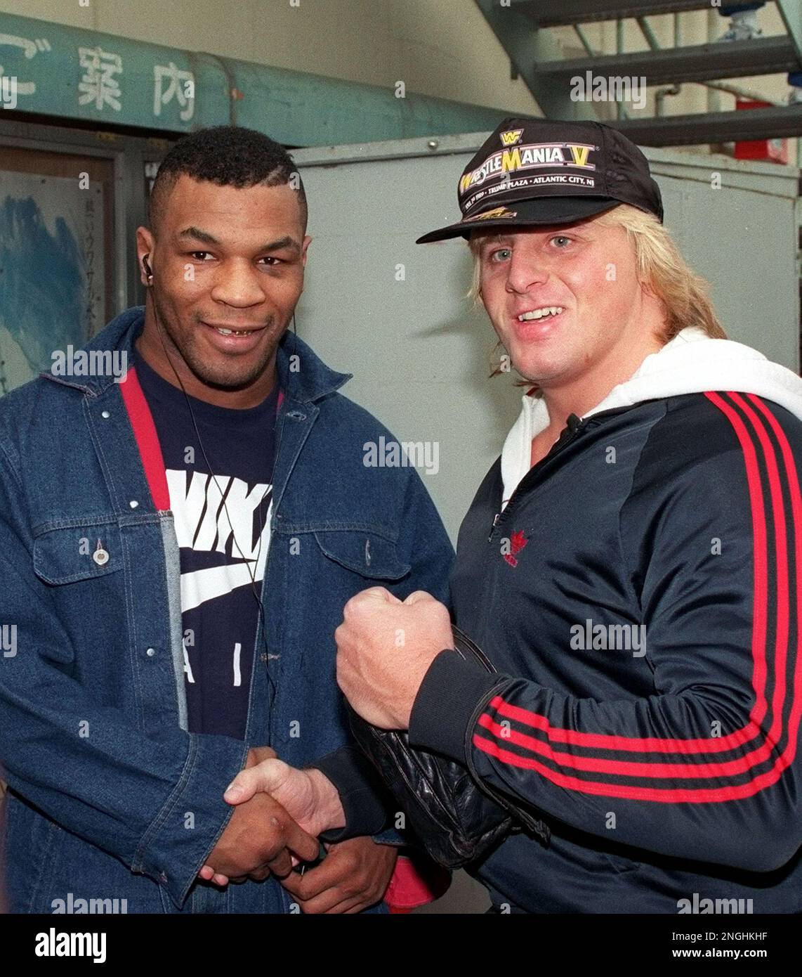Canadian professional Wrestler Owen Hart, right, poses with heavyweight boxing champion Mike Tyson at the Korakuen gym in Tokyo, Japan on Monday, Jan. 29, 1990. Hart, a father of two, was killed in May, 1999 when he plunged to his death during a wrestling stunt at Kemper Arena in Kansas City. (AP Photo/Tsugufumi Matsumoto) Stock Photo