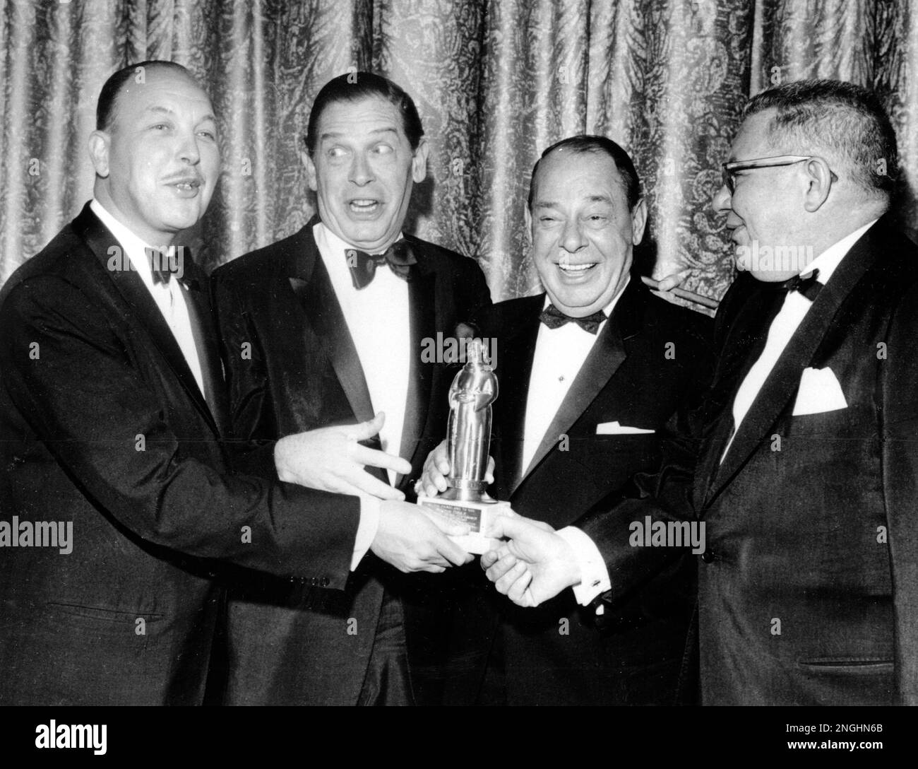Comedian Milton Berle, second from left, receives award from Friars