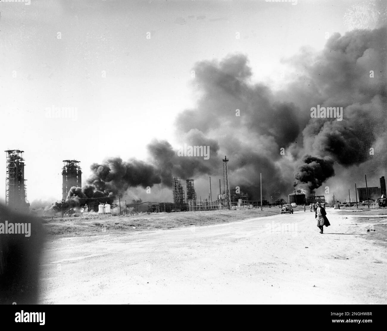 Refineries and oil storage tanks burn in the waterfront area, which was ...