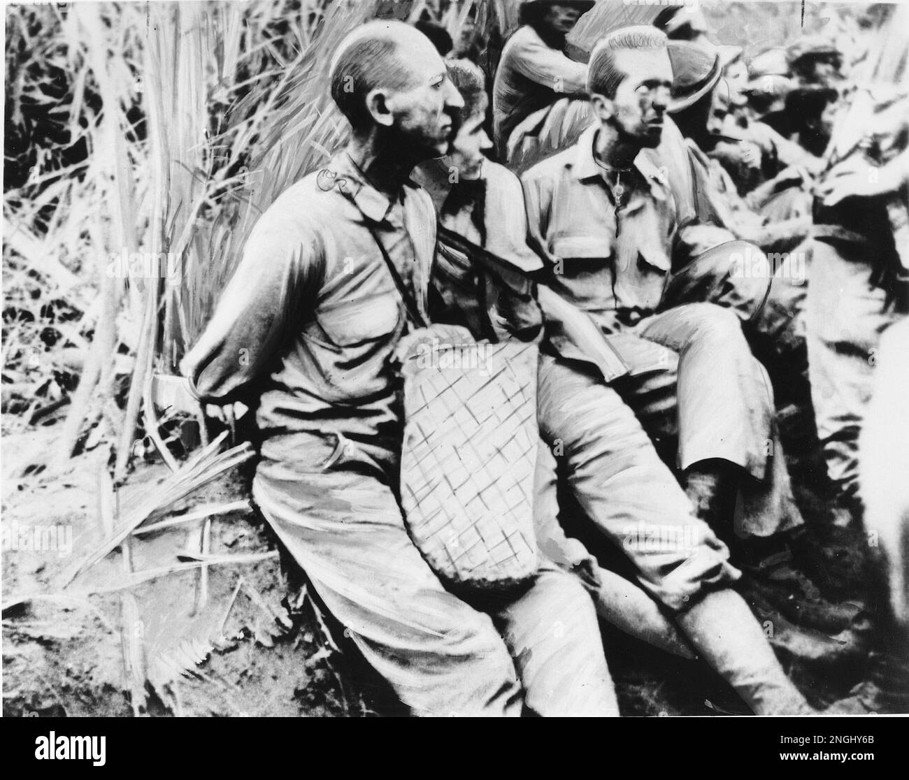 American prisoners of war pause for a moment with their arms tied ...