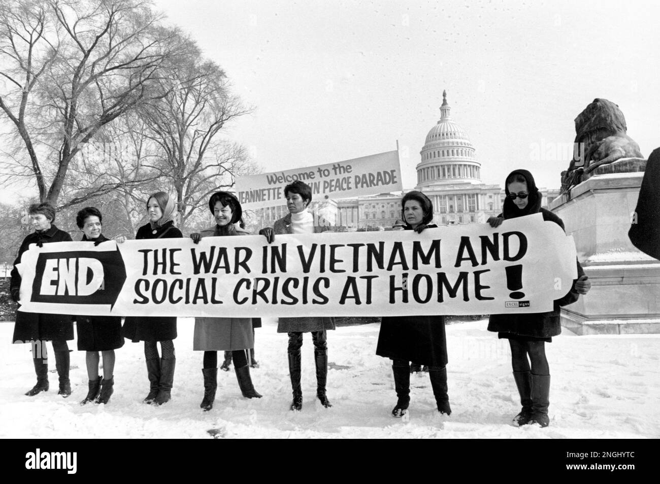 Members of a women's brigade hold a banner protesting the Vietnam War