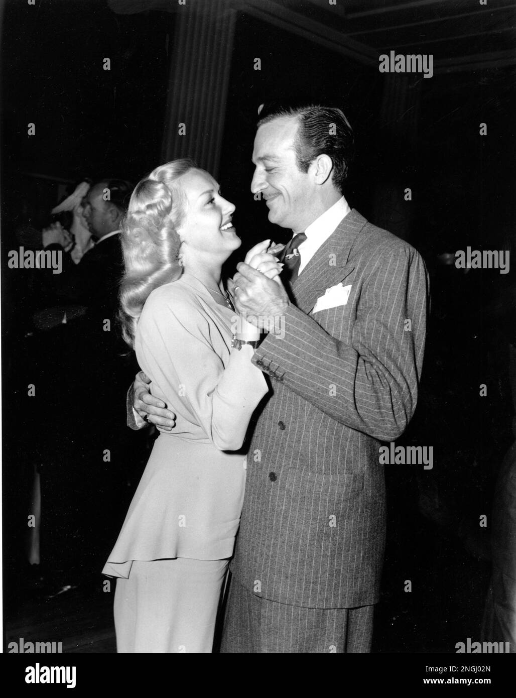 Orchestra leader Harry James and his wife, actress Betty Grable, dance