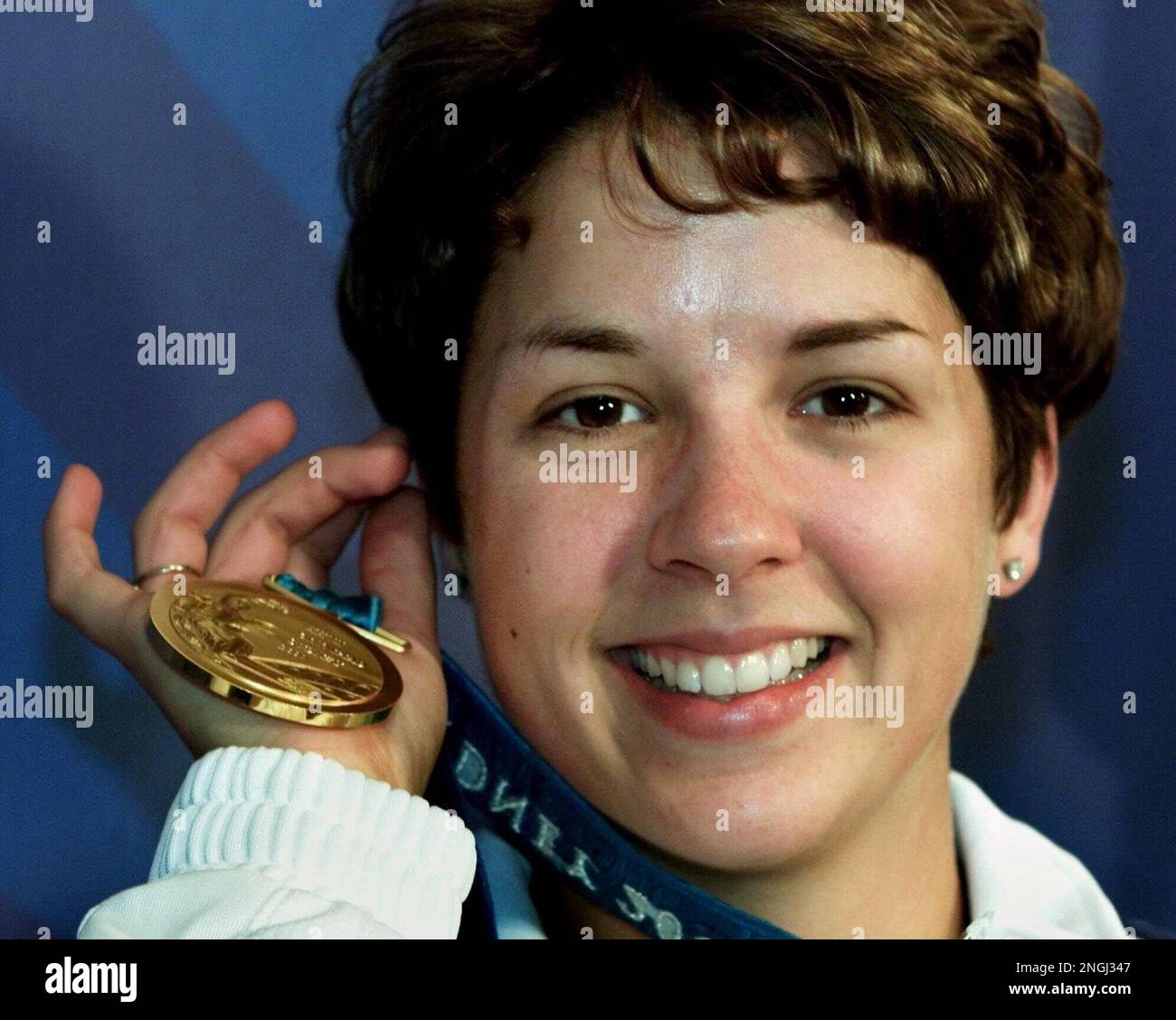 Nancy Johnson, of the United States, holds up the gold medal she won in