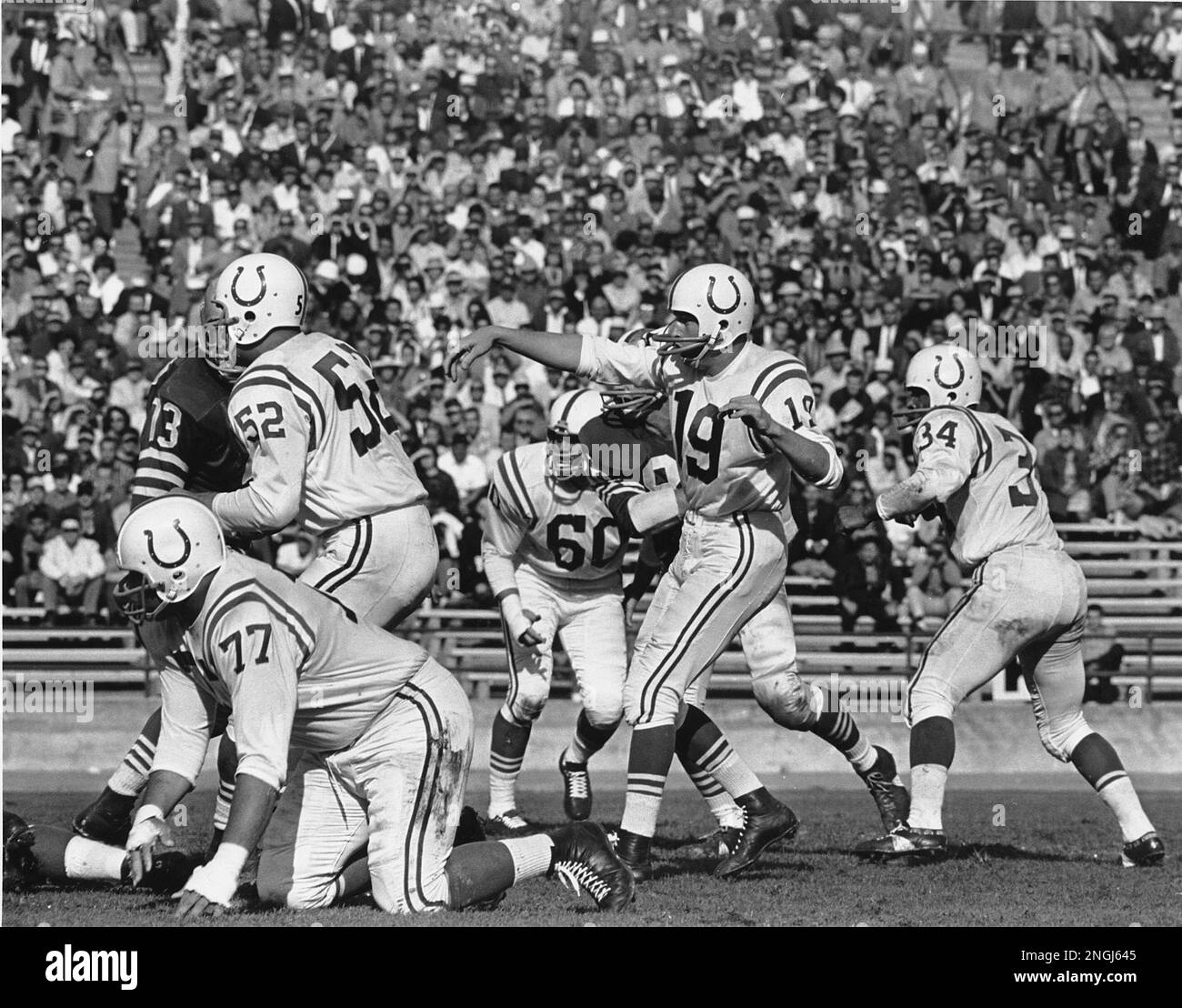 Johnny Unitas (19), quarterback of the Baltimore Colts, throws a