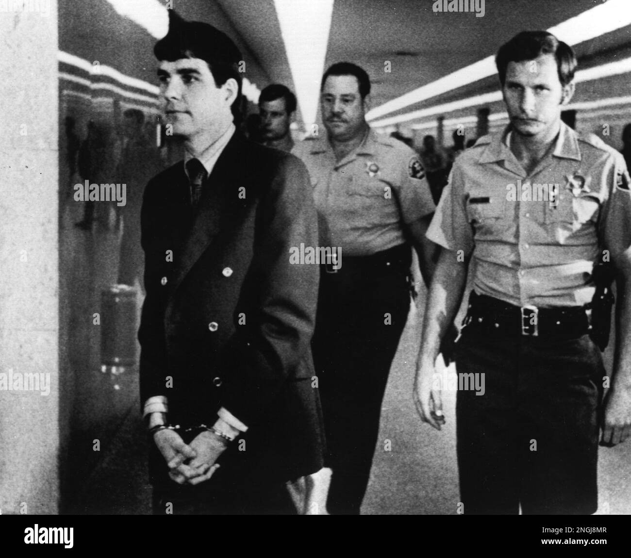 Charles "Tex" Watson is led back to jail from a courtroom in Los