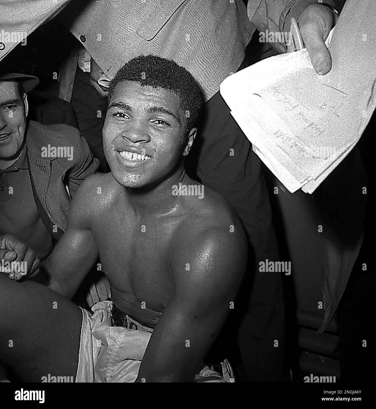 Cassius Clay faces newsmen in the dressing room at Madison Square